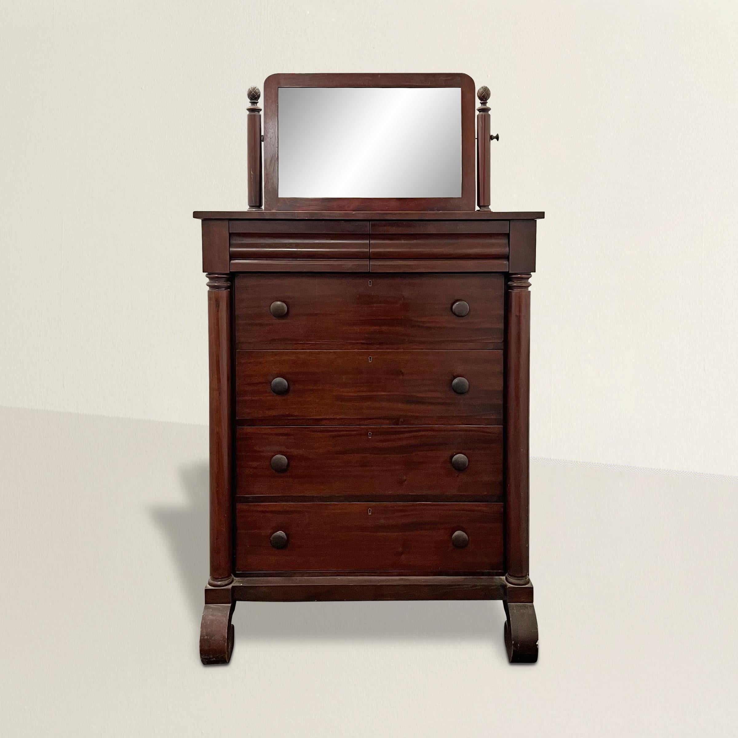 A handsome and robust late 19th century American Empire-style mahogany veneer chest of drawers with swivel vanity mirror, and two small drawers over four large drawers, made by the Cowan Furniture Company of Chicago. The perfect dresser in the guest