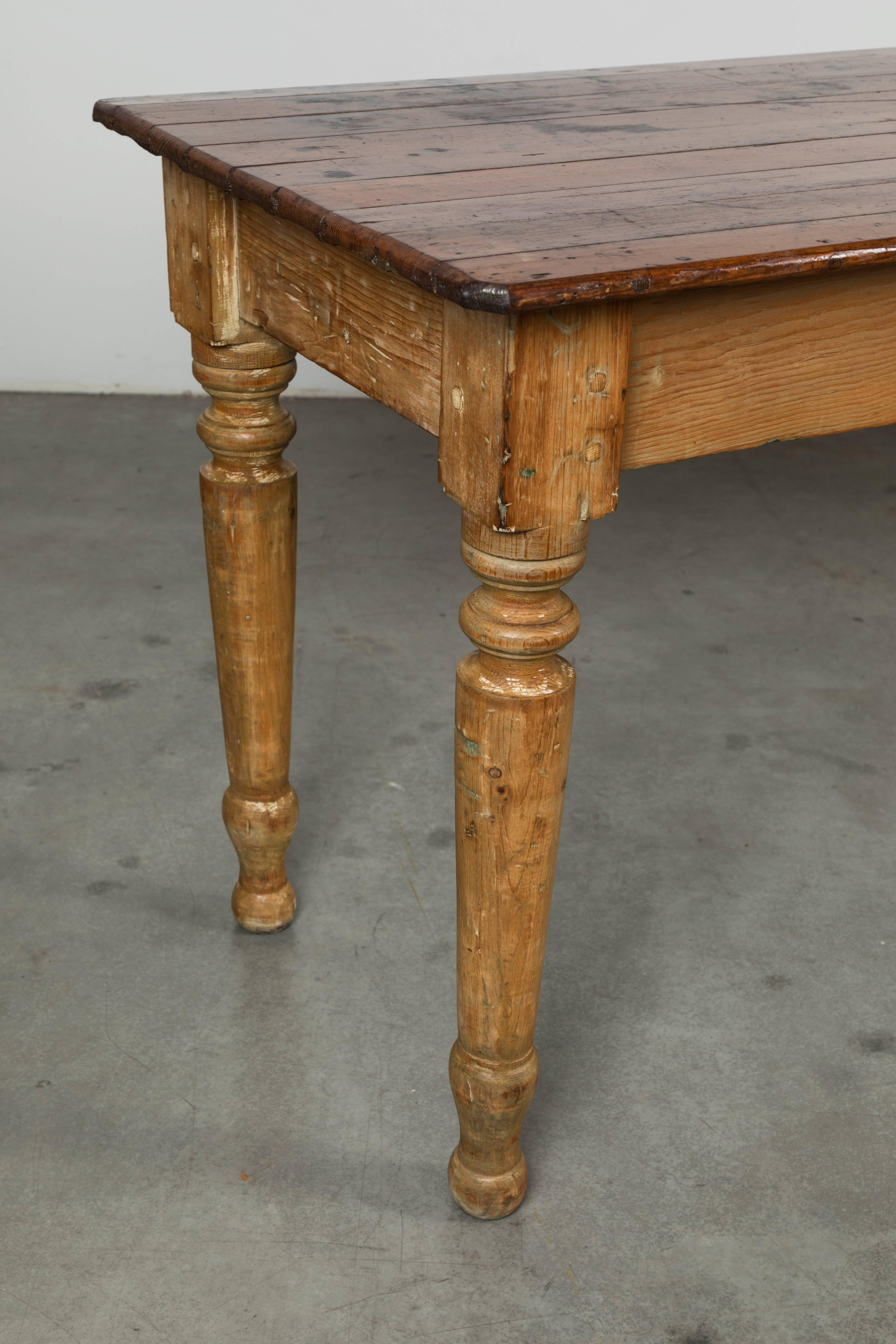 Great late 19th century general store counter with nicely turned legs. Perfect large dining table or centre island for work kitchen. A total workhorse. Could have casters put on to raise for work table. A trace layers of old paint and stain. Legs