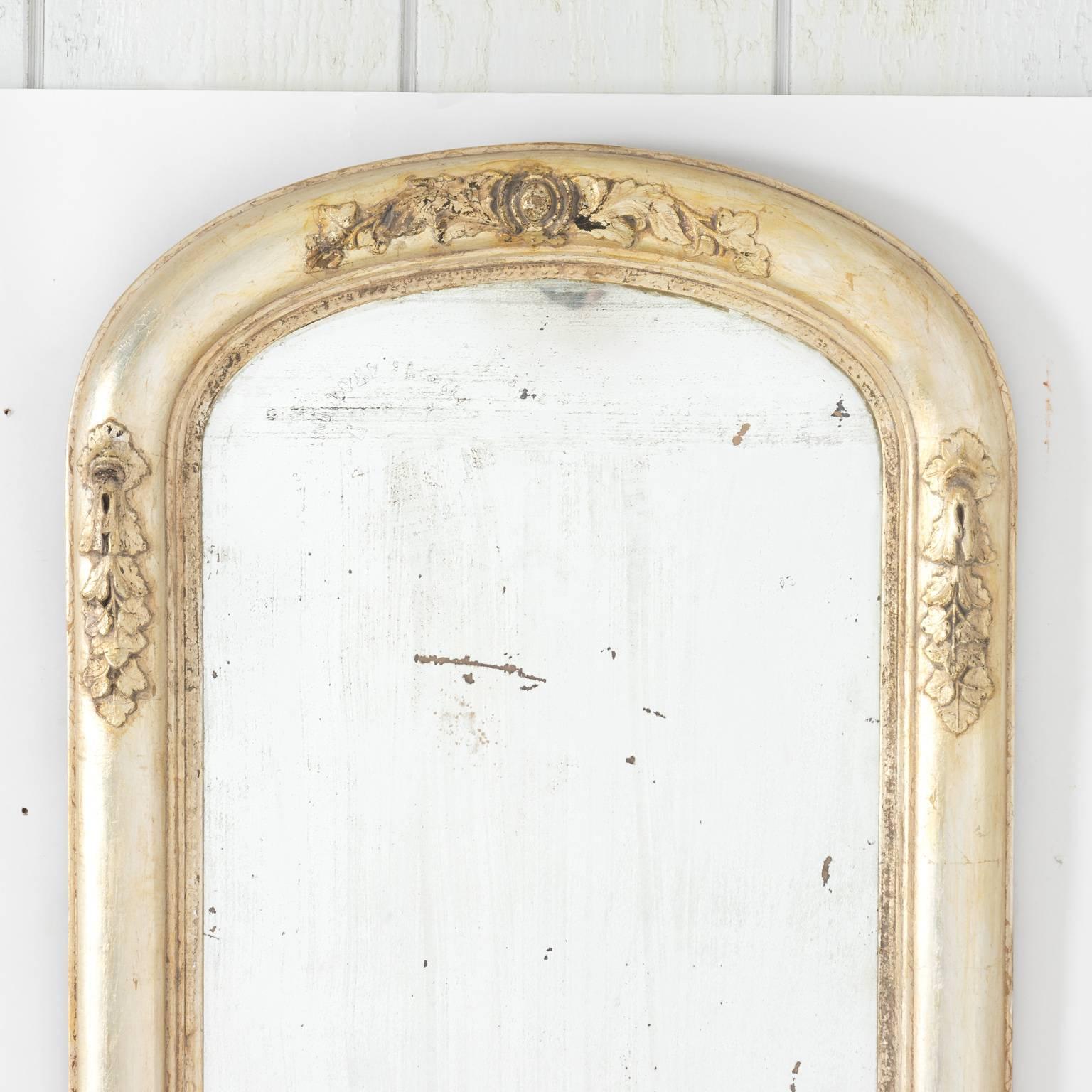 American Rococo style mirror in a silver leaf frame, circa late 19th century.
 