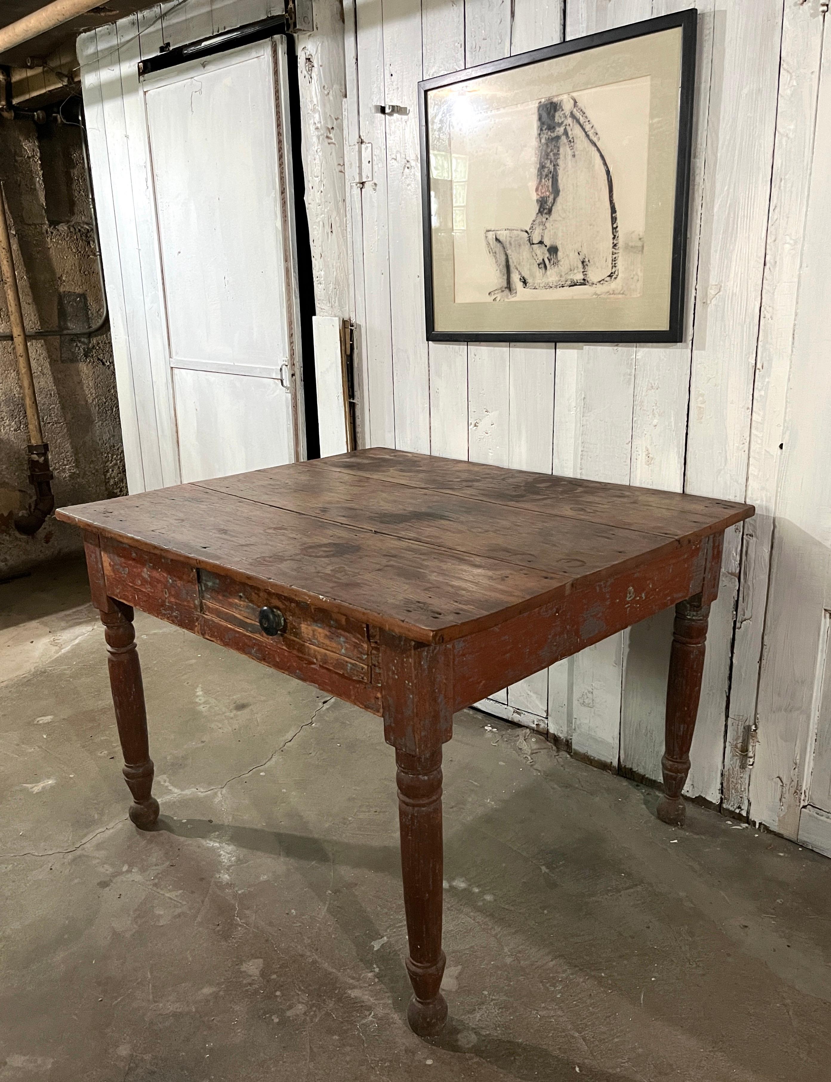 Late 19th century primitive, farmhouse kitchen table or small dining table. Solid pine with great green paint residue on sides. Three-plank top and turned legs. One small off-center drawer. 

Unusual almost-square top. Would also work well as a