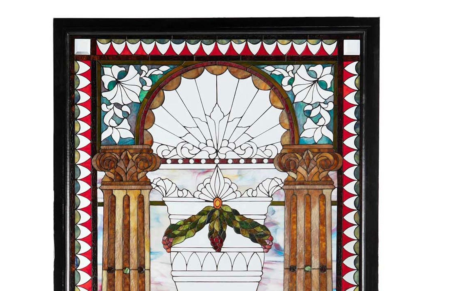 Late 19th century American Victorian leaded glass window (Tiffany quality)

The multi-colored window with leaded slag glass, rippled glass, opalescent glass, and clear bevel glass in pastel colors with floral and urn central motifs in between two