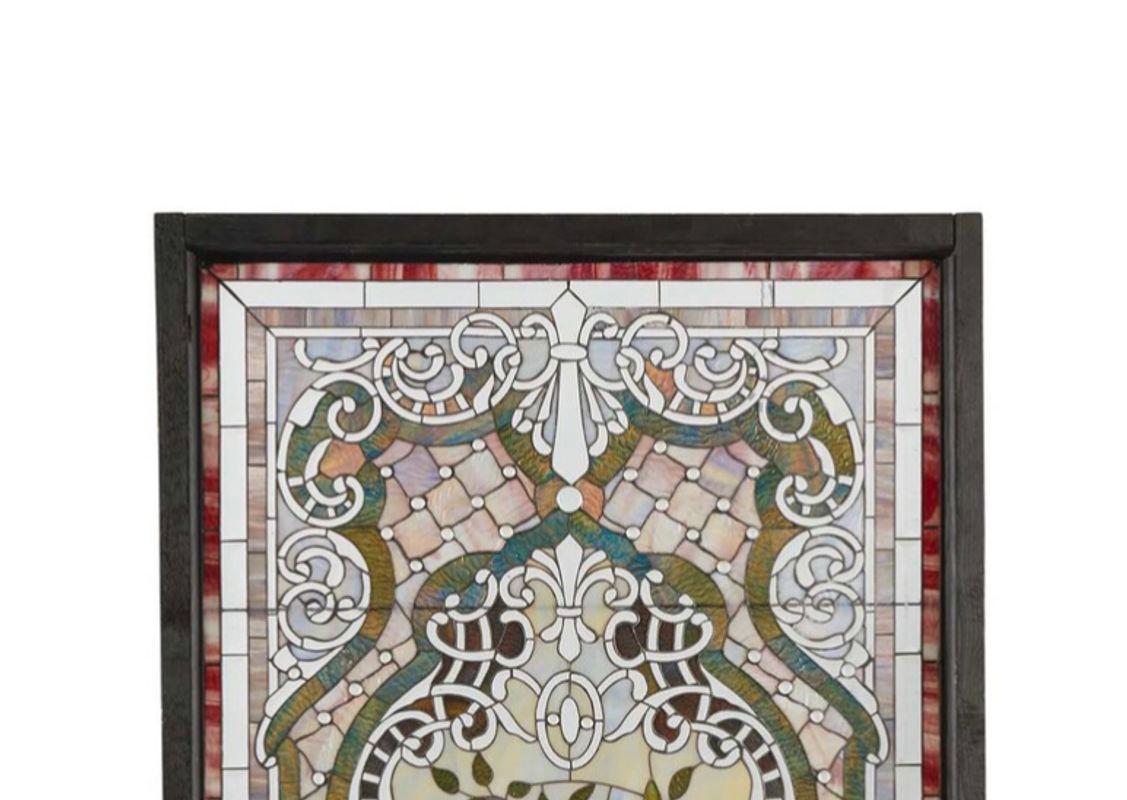 The multi-colored window with slag glass, rippled glass, and opalescent and clear beveled glass in pastel colors with floral and urn central motifs and clear optic jewels throughout

Dimensions

70