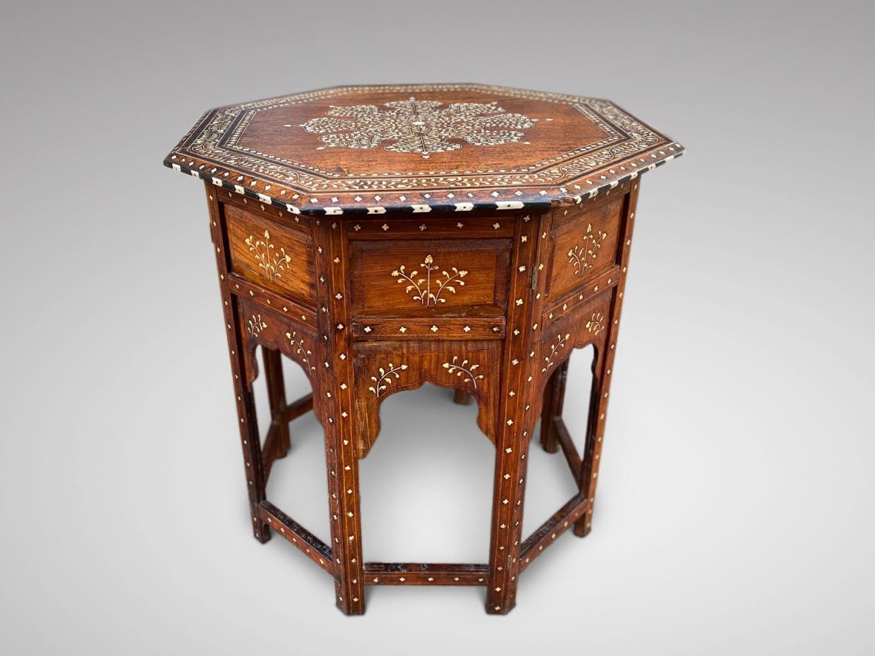 We are delighted to offer for sale this large late 19th century octagonal Anglo Indian Hoshiarpur bone and ebony inlaid table on a folding base. Moulded chevron edge. The base has 8 legs with adjoining stretcher rails of which are decoratively