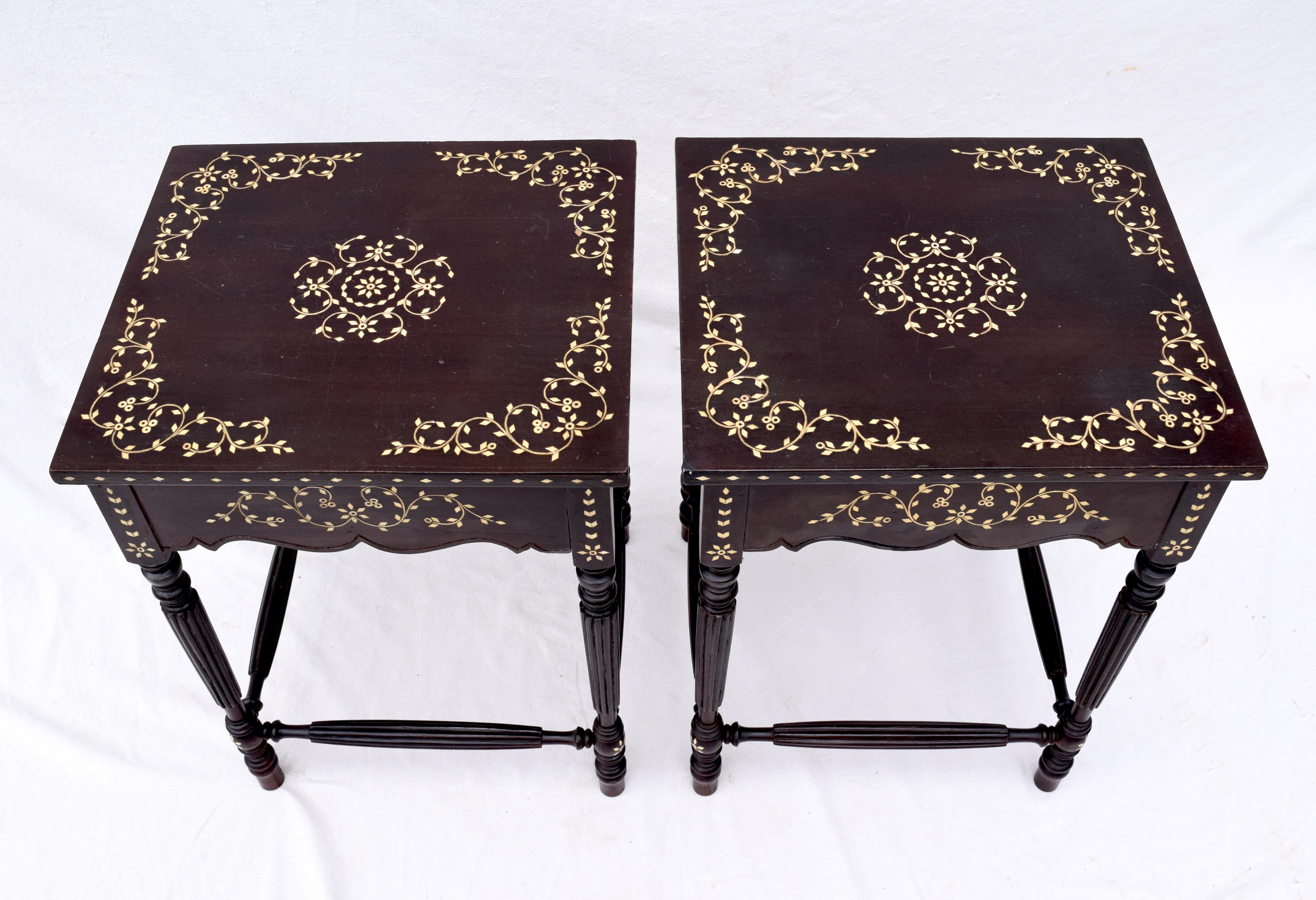 A pair of late 19th century Anglo-Indian side tables crafted in Mahogany with exotic bone inlays throughout. Beautifully maintained original finish. An unusual design with reeded turned legs & stretchers suitable in a variety of settings.