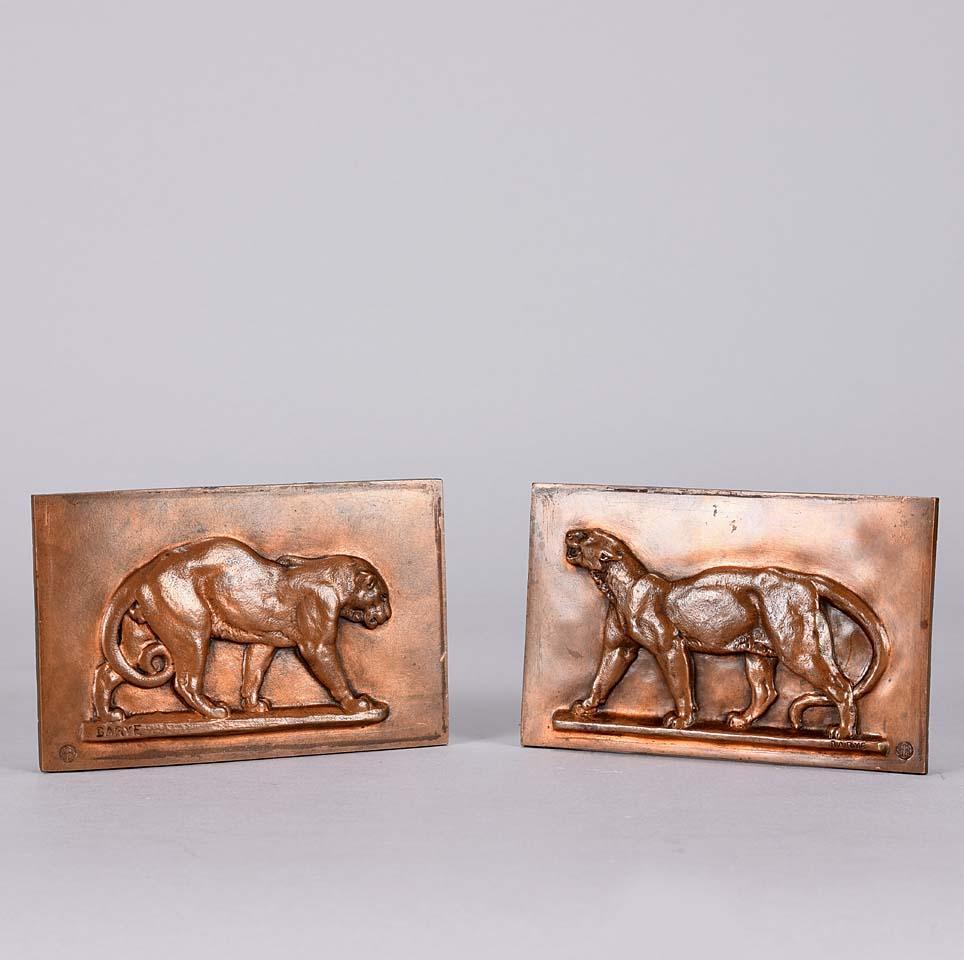 A pair of majestic late 19th century animalier bronze plaques one decorated with a striding panther the other of a striding leopard. The bronze plaques with excellent hand chased surface detail and very fine rich mid to golden brown patina, signed