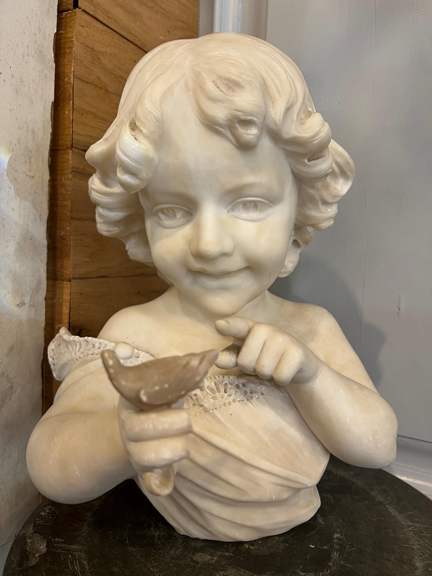 Fabulous antique alabaster bust of a young girl holding a small bird. The details are amazing and the young girl has a beautiful smile as she points to the small bird. She's in good condition but is missing parts of her fingers in the hand holding