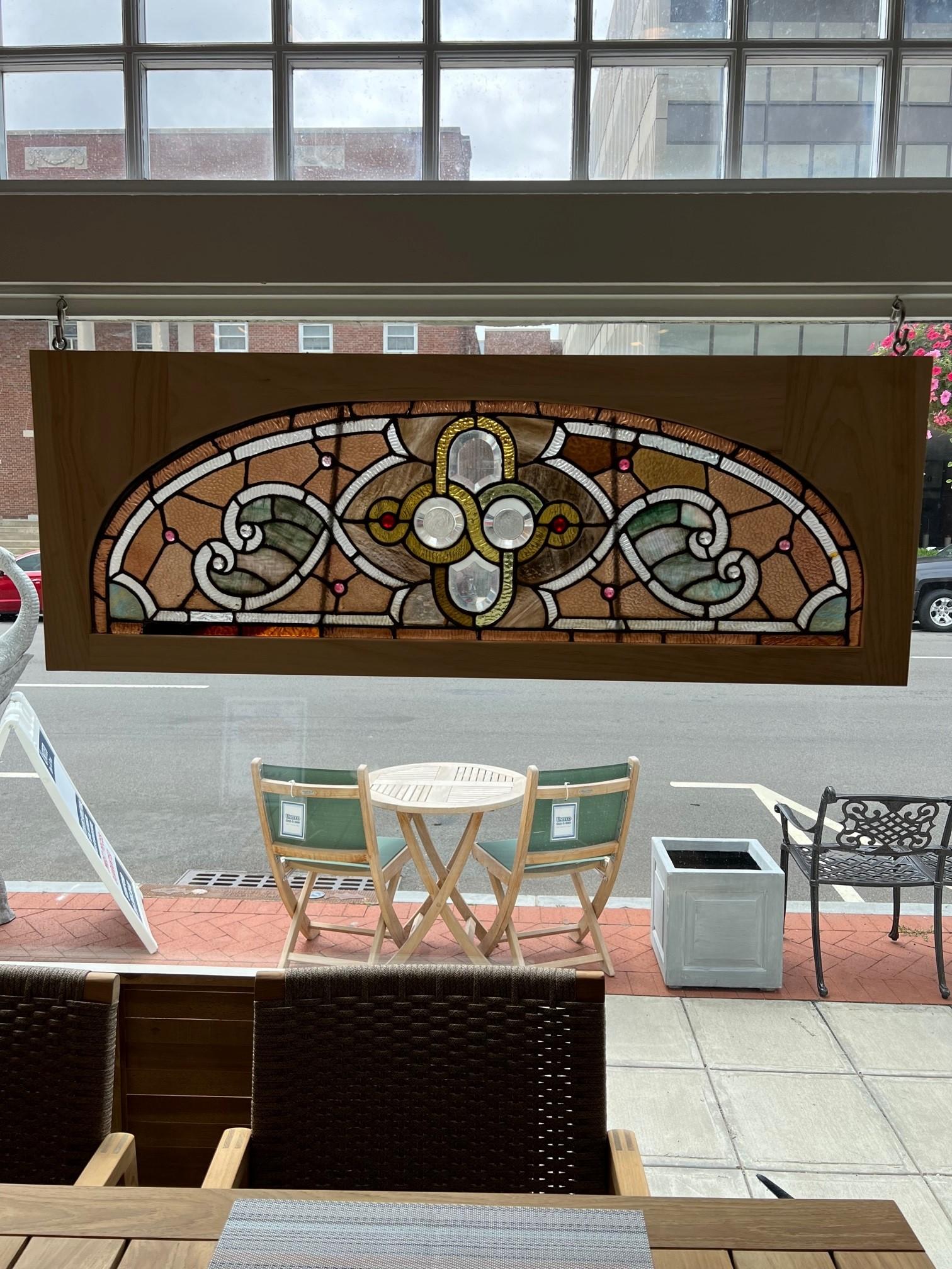 Beautiful antique stained glass arch transom window in a new wood frame. Late 19th century window salvaged from an estate outside Pittsburgh PA. This is a combination window with both stained and beveled glass panels 
This is one of three stained