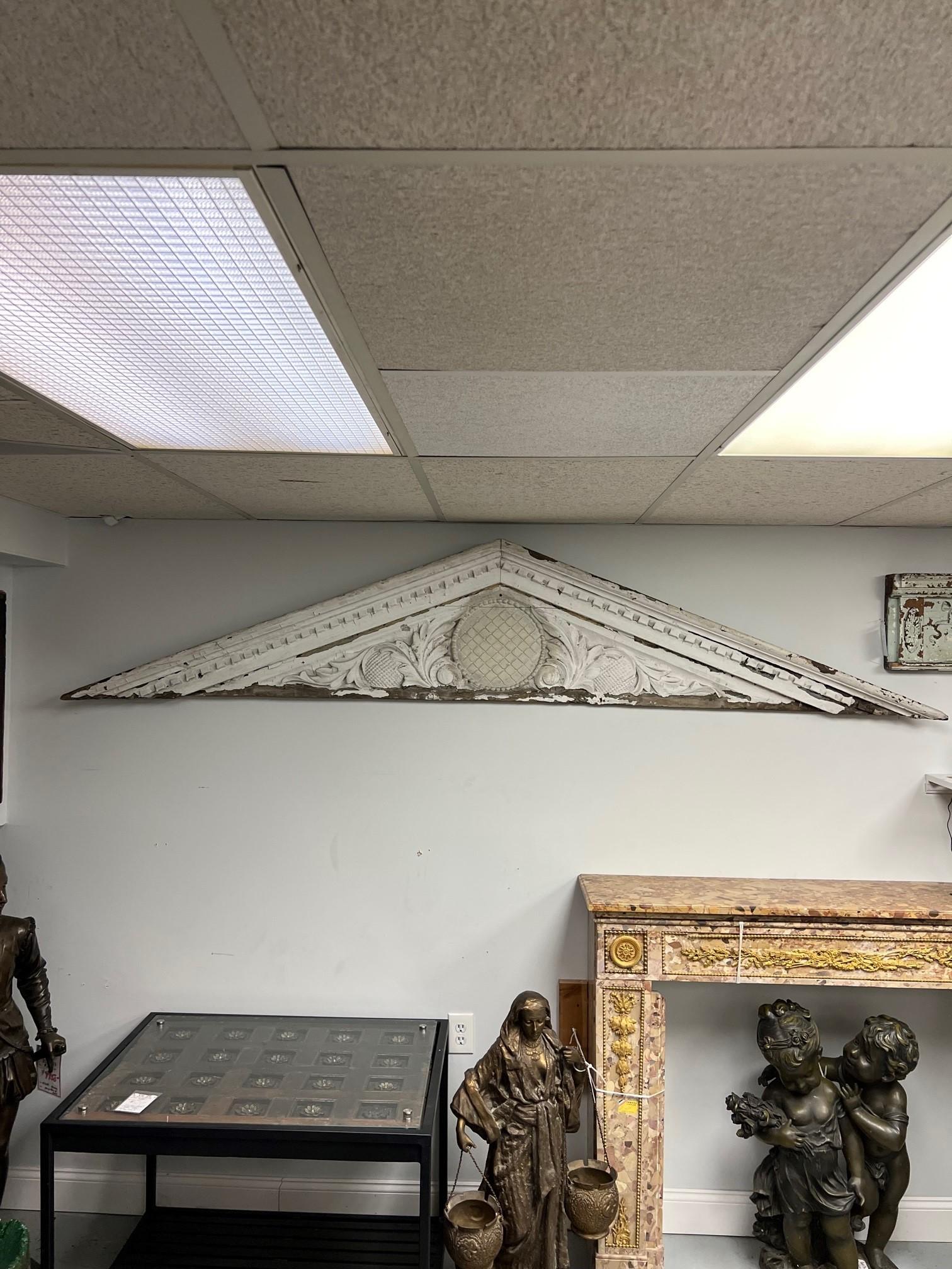 Late 19th century, architectural antique carved wood overdoor pediment. Salvaged from a late 19th century Victorian home in New Haven Ct. The pediment still has the original paint which looks great, it can also be stripped or painted. This is a nice