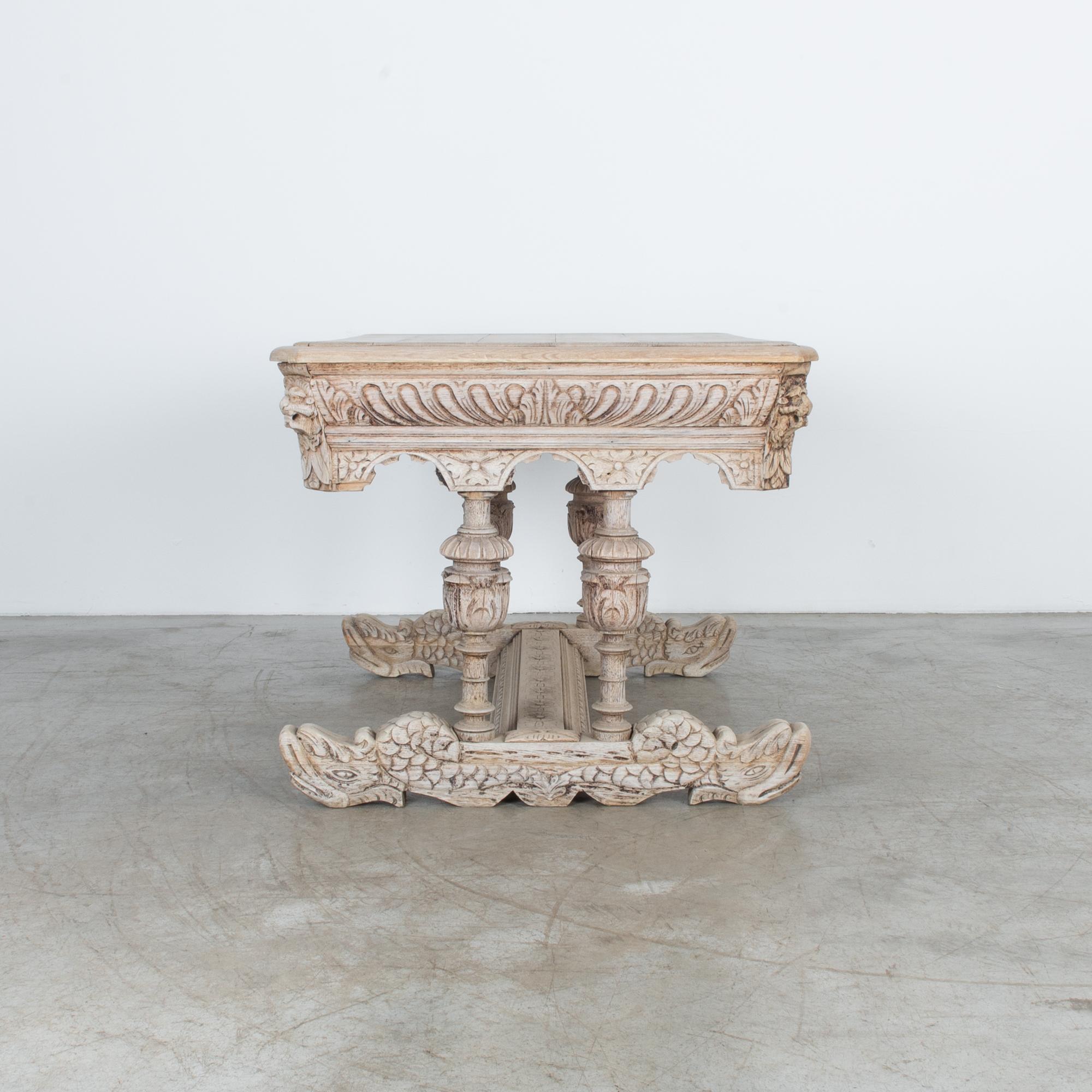 Impressive carved legs and base on this beautiful table. With a unique Rococo influence, this Flemish style table expands the classical dolphin motif. The elaborately carved base depicts two dolphin figures. Ornate carved legs and thick apron