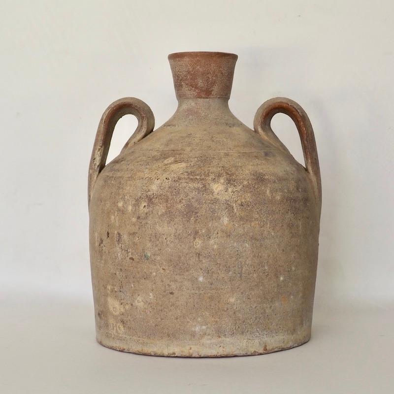 An antique Portuguese bell shaped terracotta jug with fluted spout and double handles. The distinctive 'Cloche' shape ensured the jars were stable when stored for transit. 

Jugs such as these were used throughout Iberia for water, oil and wine