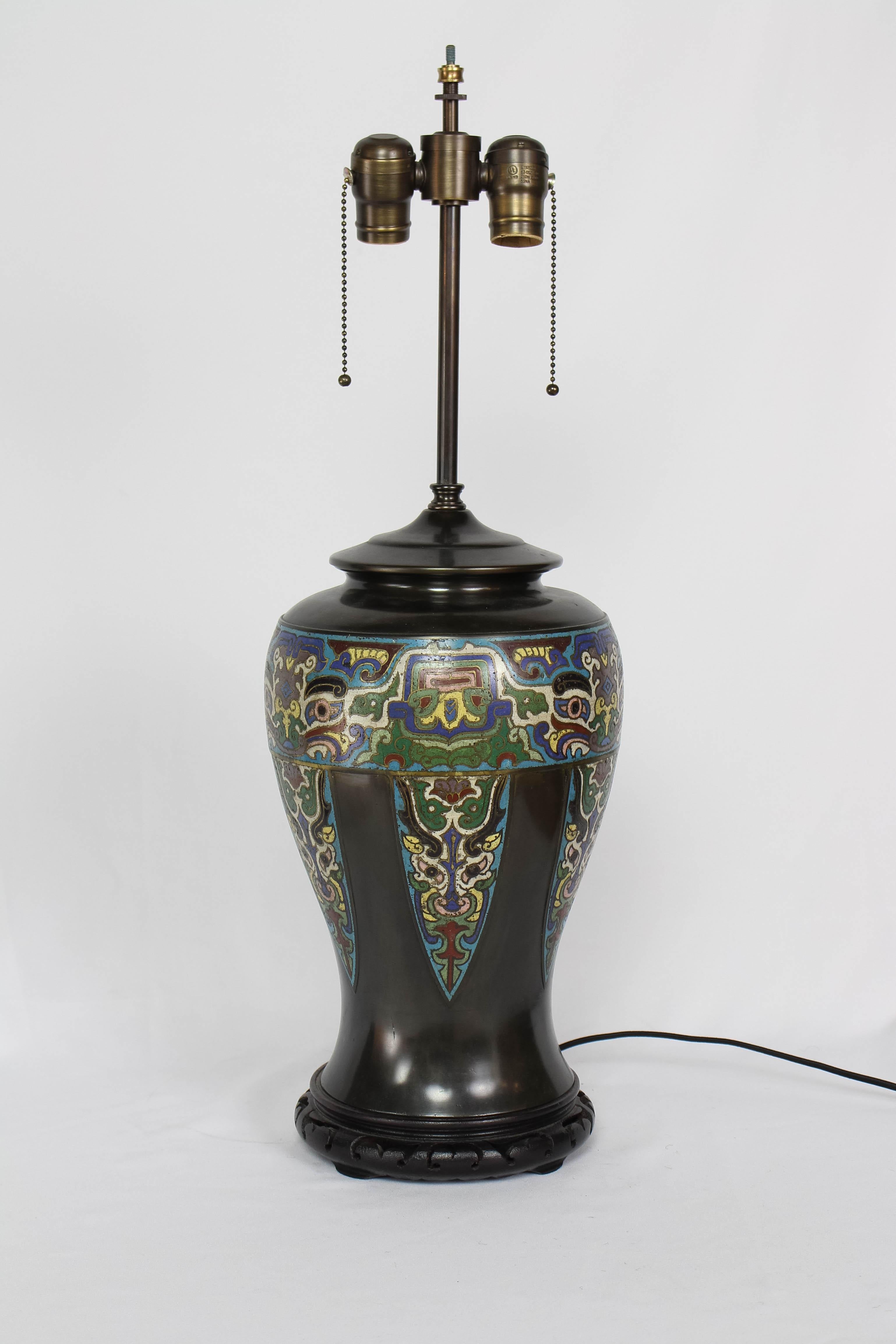 Asian Antique Champleve table lamp. Totem like design
Beautifully patinated bronze with Champleve in a band around the vase and with spears pointing down. The Champleve design in very good condition, and the design features distinctive eyes.