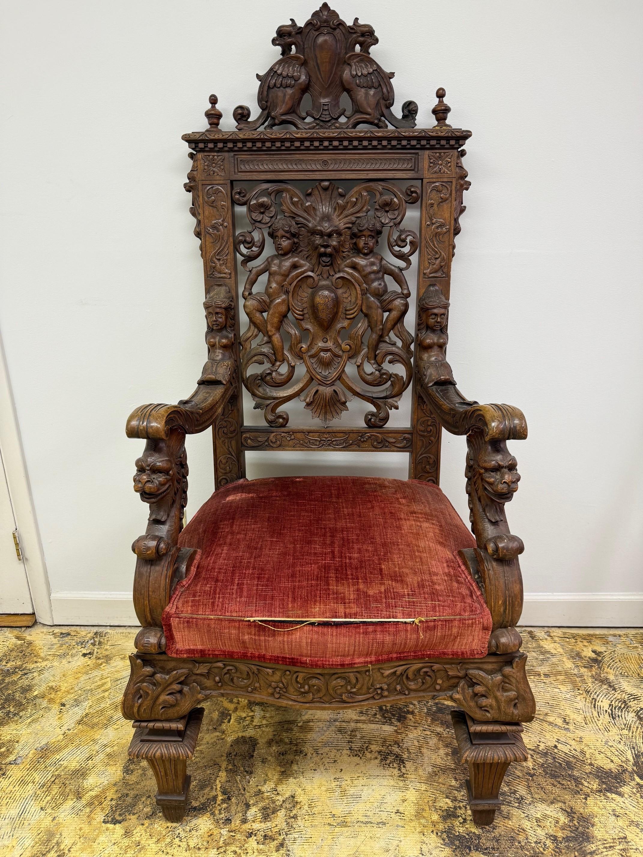 Late 19th Century antique very decorative carved throne chair with amazing details. This antique carved throne chair has full carved figures and masks similar to R.J.Horner & Co. The carvings are in good condition and the chair is very sturdy. The