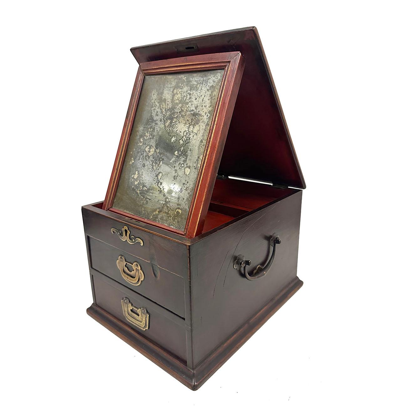This beautiful antique Jewelry box was made from solid wood with original mirror and antique hardware on it. The top of the jewelry box can be lift open and has a mirror stand attached on it and can be used as a cosmetic box. Underneath the mirror