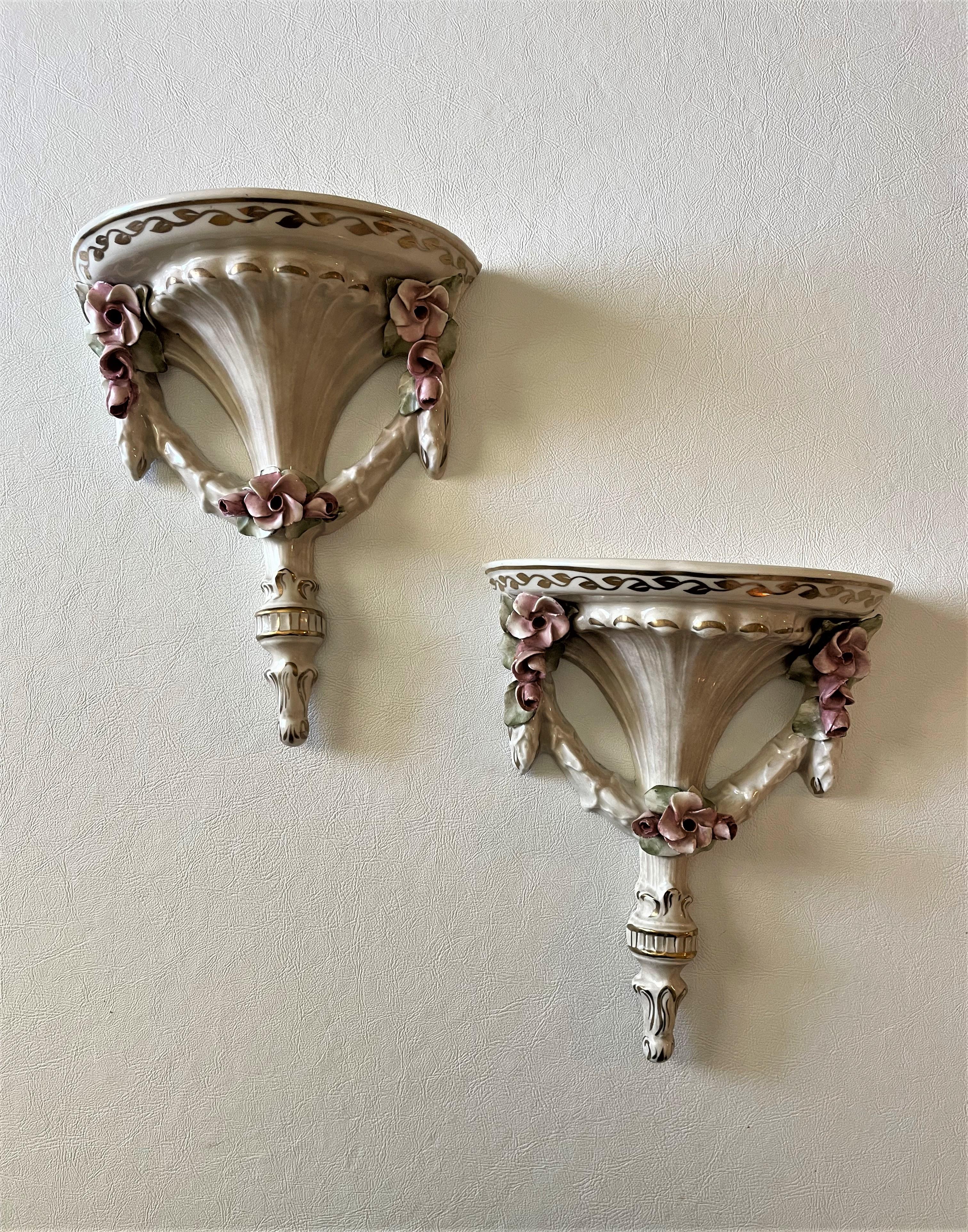 This pair of antique French decorative wall brackets dates to the 19th century. They are unusual for their mint condition and for their elegant but not 'overdone' motifs -- There is nothing Rococo about this pair of wall brackets, which is typically
