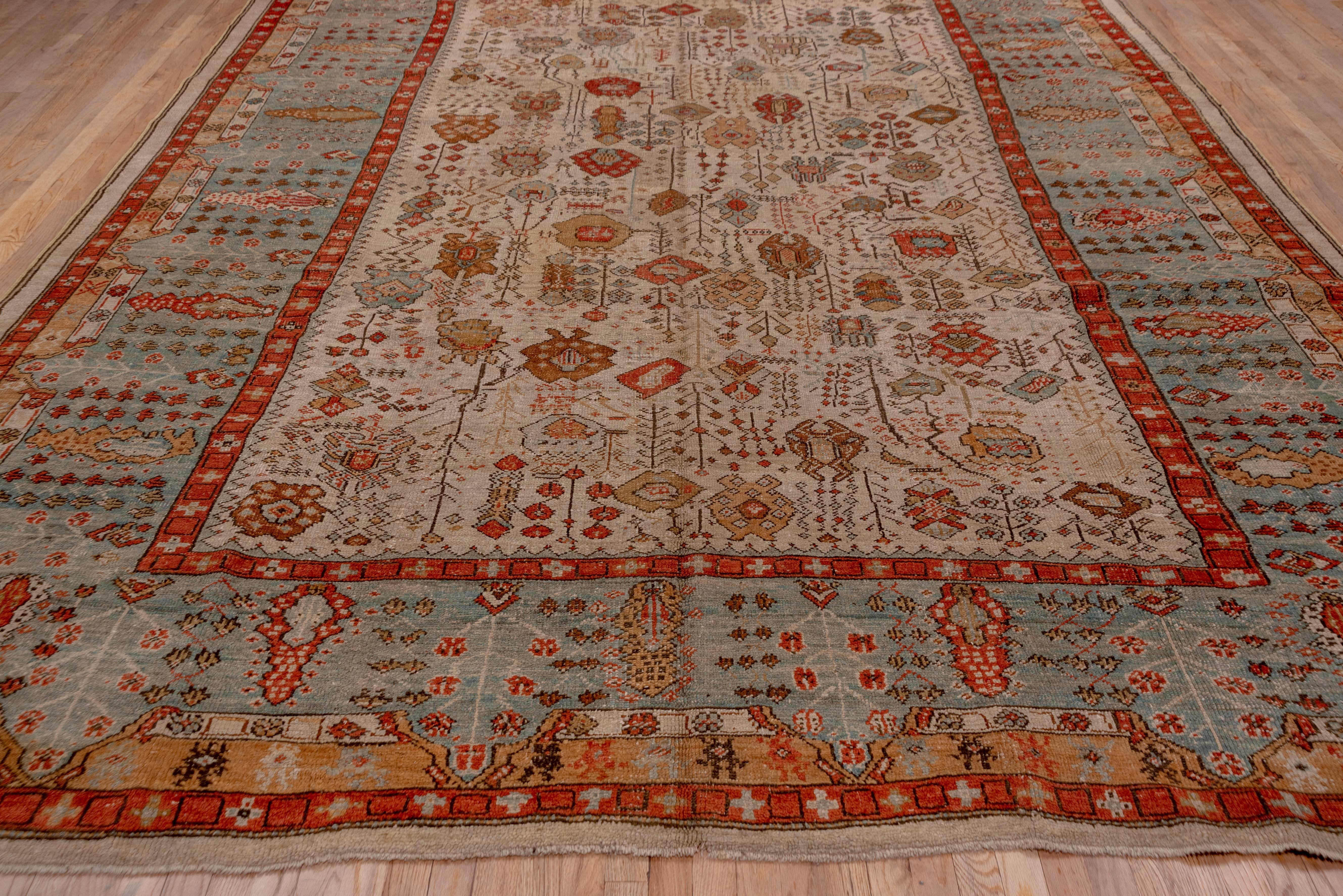 Ghiordes is near to Oushak and influences pass in both directions. This attractive west Anatolian workshop carpet displays a relatively small ivory field decorated with highly abstract palmettes, stem segments, bud arrays and geometric devices. The