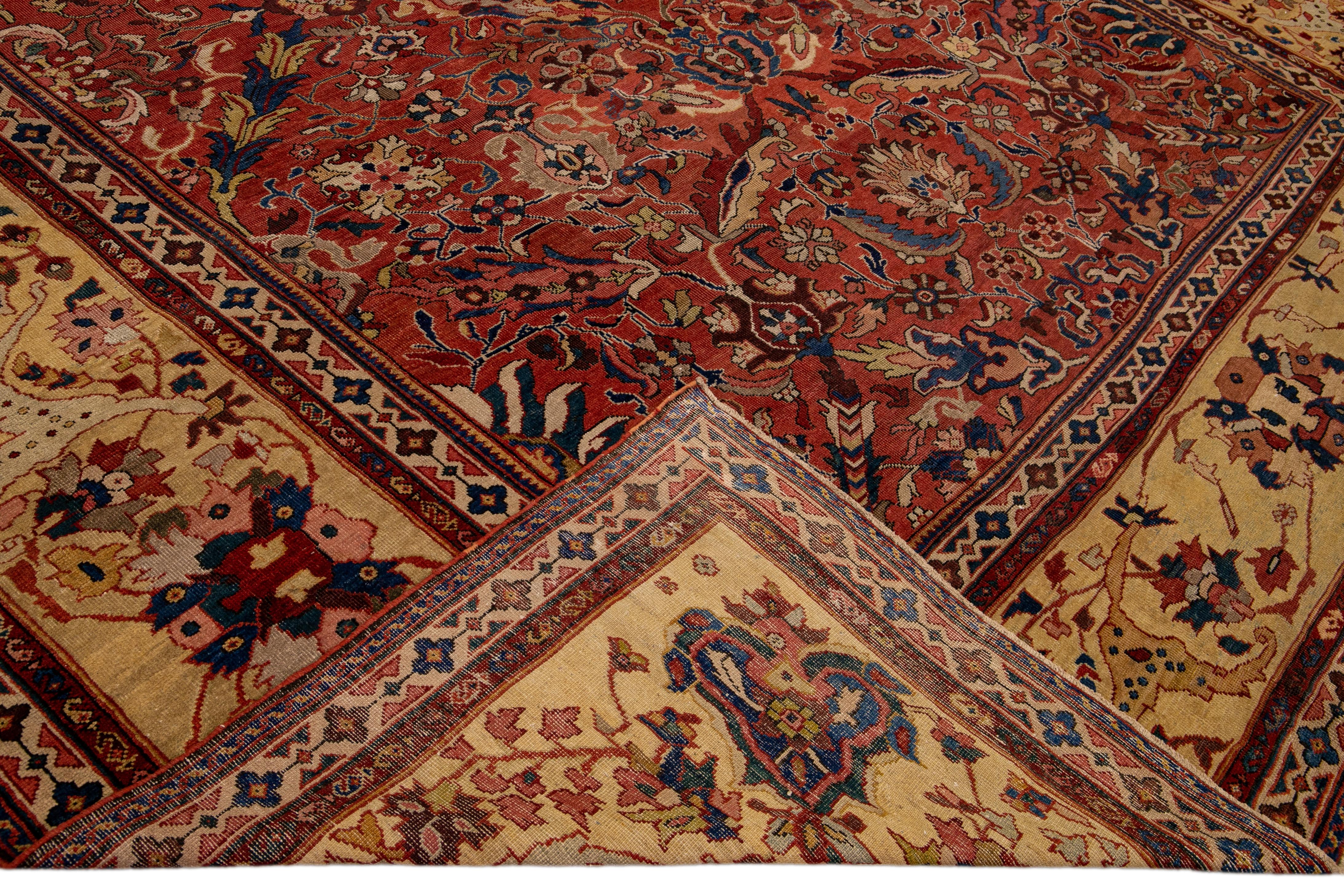 Beautiful antique Mahal oversize wool rug with a rust field. This Persian rug has a tan-designed frame and multicolor accents in all-over floral design.

This rug measures: 12'9