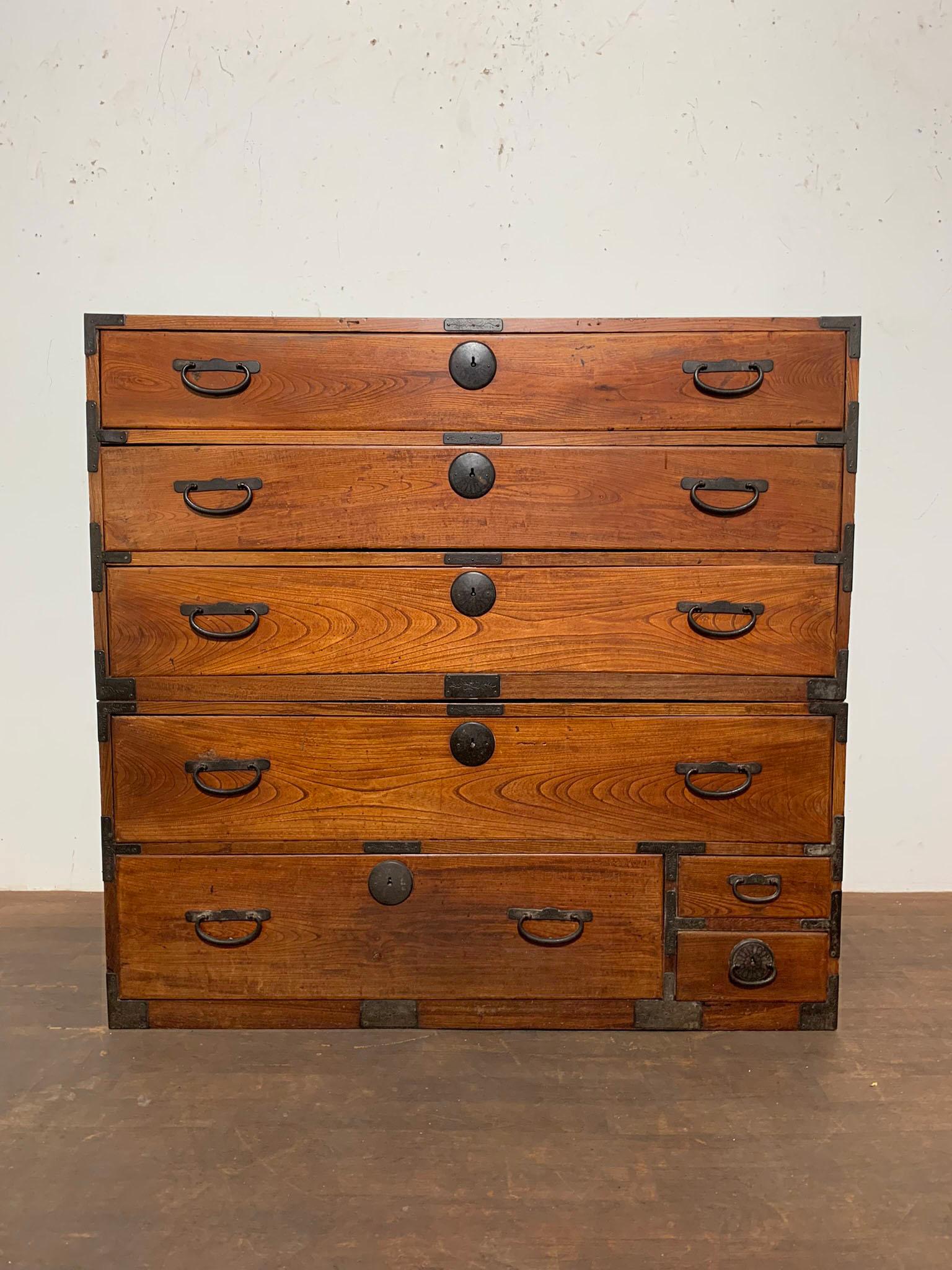 A late 19th century Japanese two-piece tansu chest in kiri wood with original hand forged iron hardware.