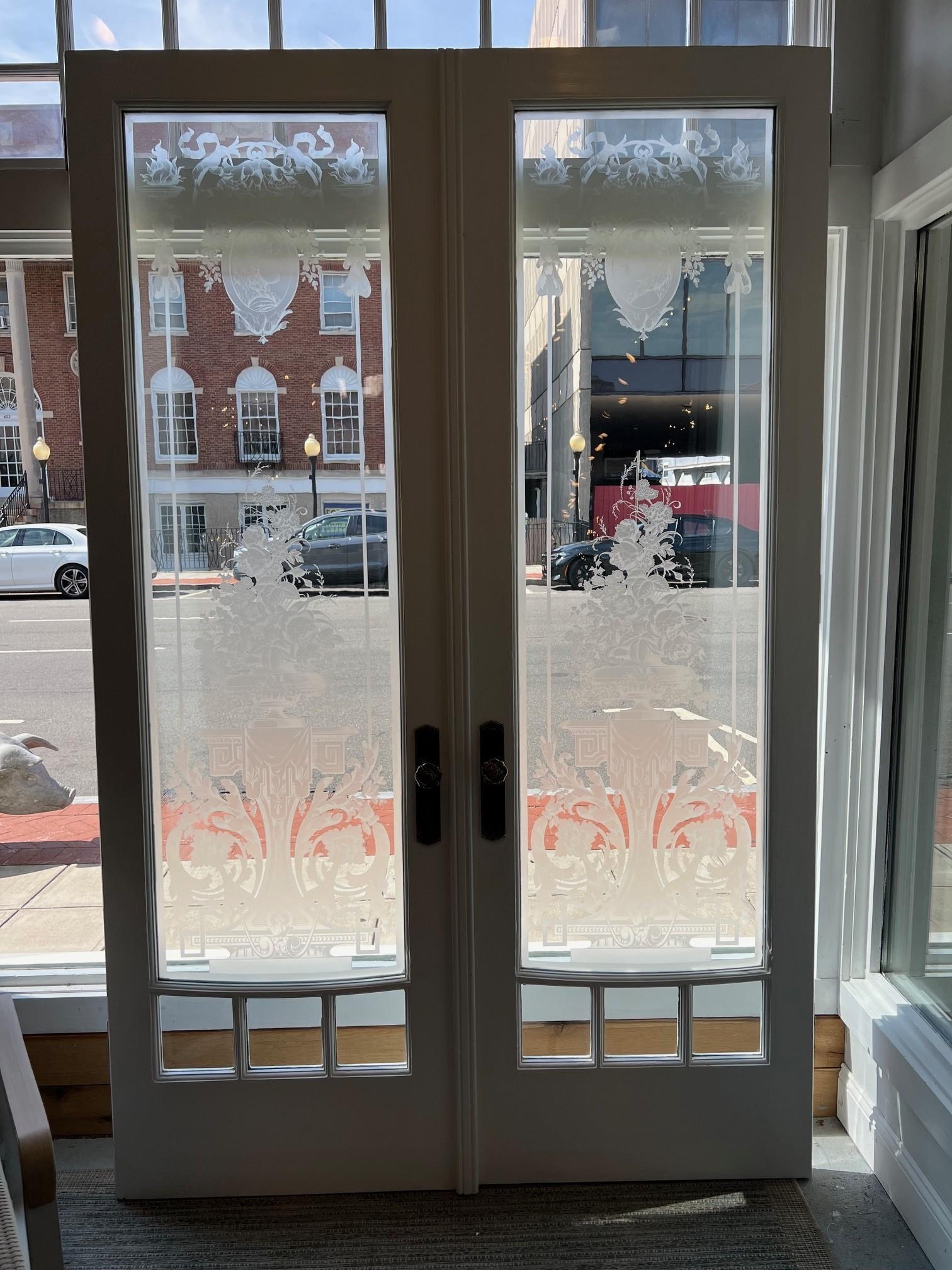 Fabulous pair of late 19th Century antique acid etched glass doors, salvaged originally from Paris France. Each panel has a bouquet of flowers in a large urn with wonderful scroll work. The top of the each panel has a beautiful male and female bust