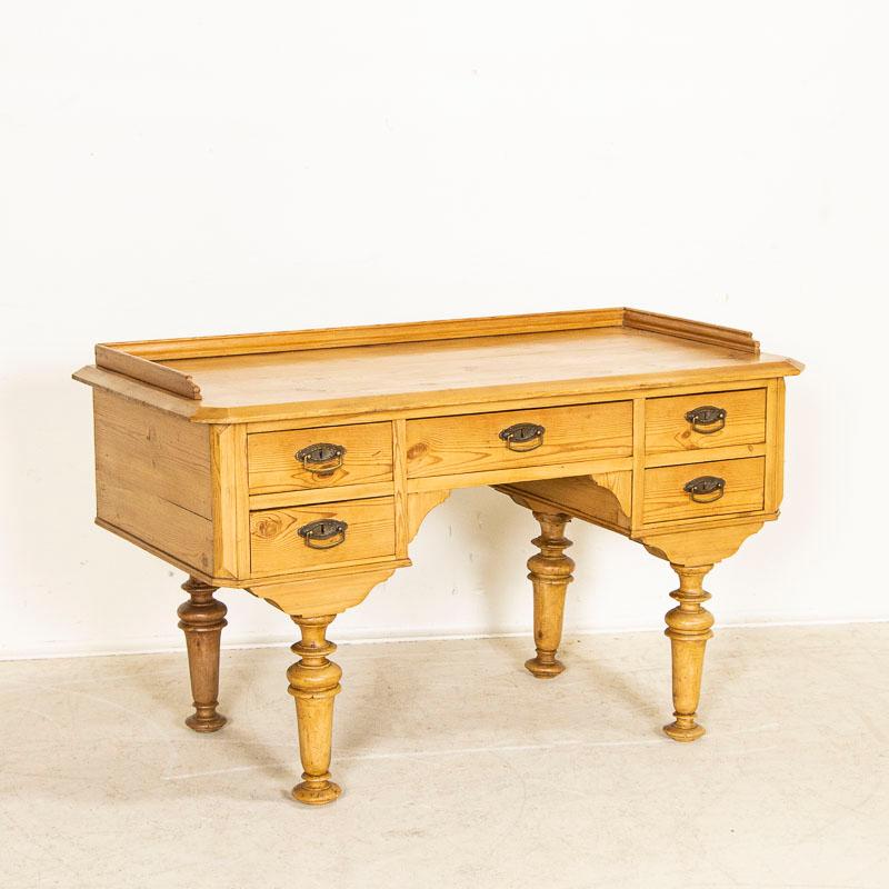 This delightful antique desk is known as a 