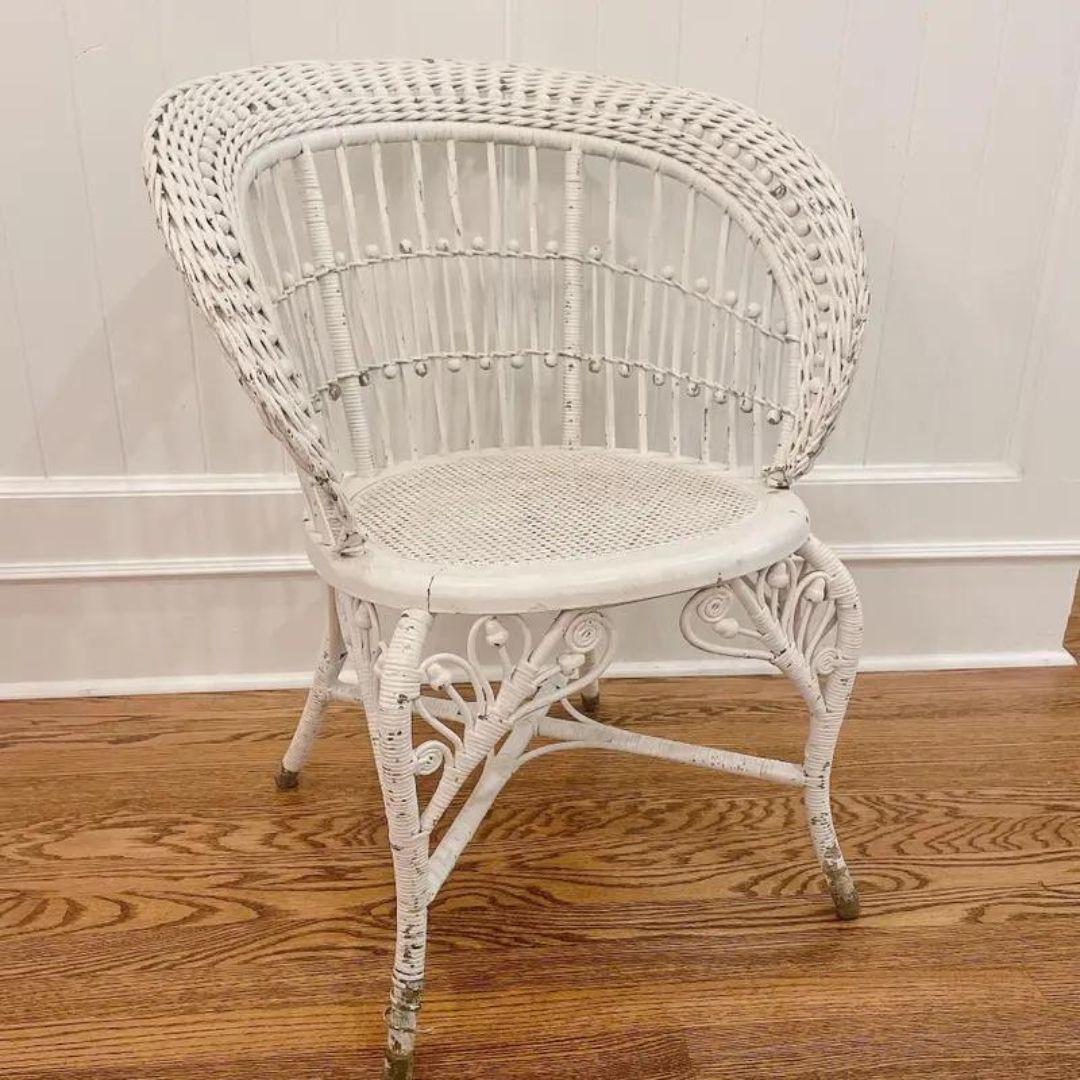 A truly wonderfully preserved example of Victorian stick and ball fiddlehead style. Great Patina. This fanciful hand made chair features ball and stick designs, skilled scrollwork, splayed capped feet. Wicker chair circa late 1800's. Attributed to