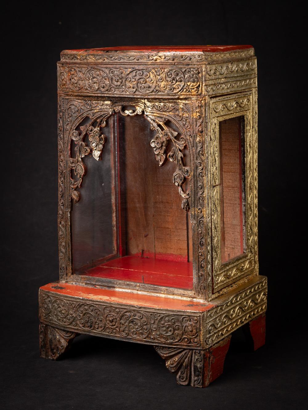This Late 19th-century wooden Burmese Buddha temple is a stunning testament to the rich spiritual and artistic heritage of Burma. Crafted from wood and standing at a height of 42.2 cm, with dimensions of 26.3 cm in width and 20.8 cm in depth, it