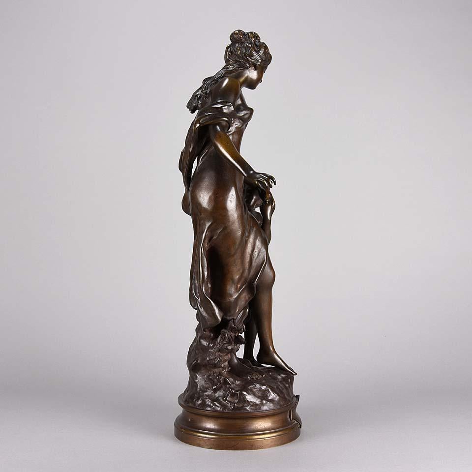 A charming late 19th Century bronze study of an Art Nouveau beauty standing with a young girl dressed in loosely fitted attire exhibiting excellent hand finished detail and rich colour. Raised on a bronze base, signed Math Moreau, and inscribed on