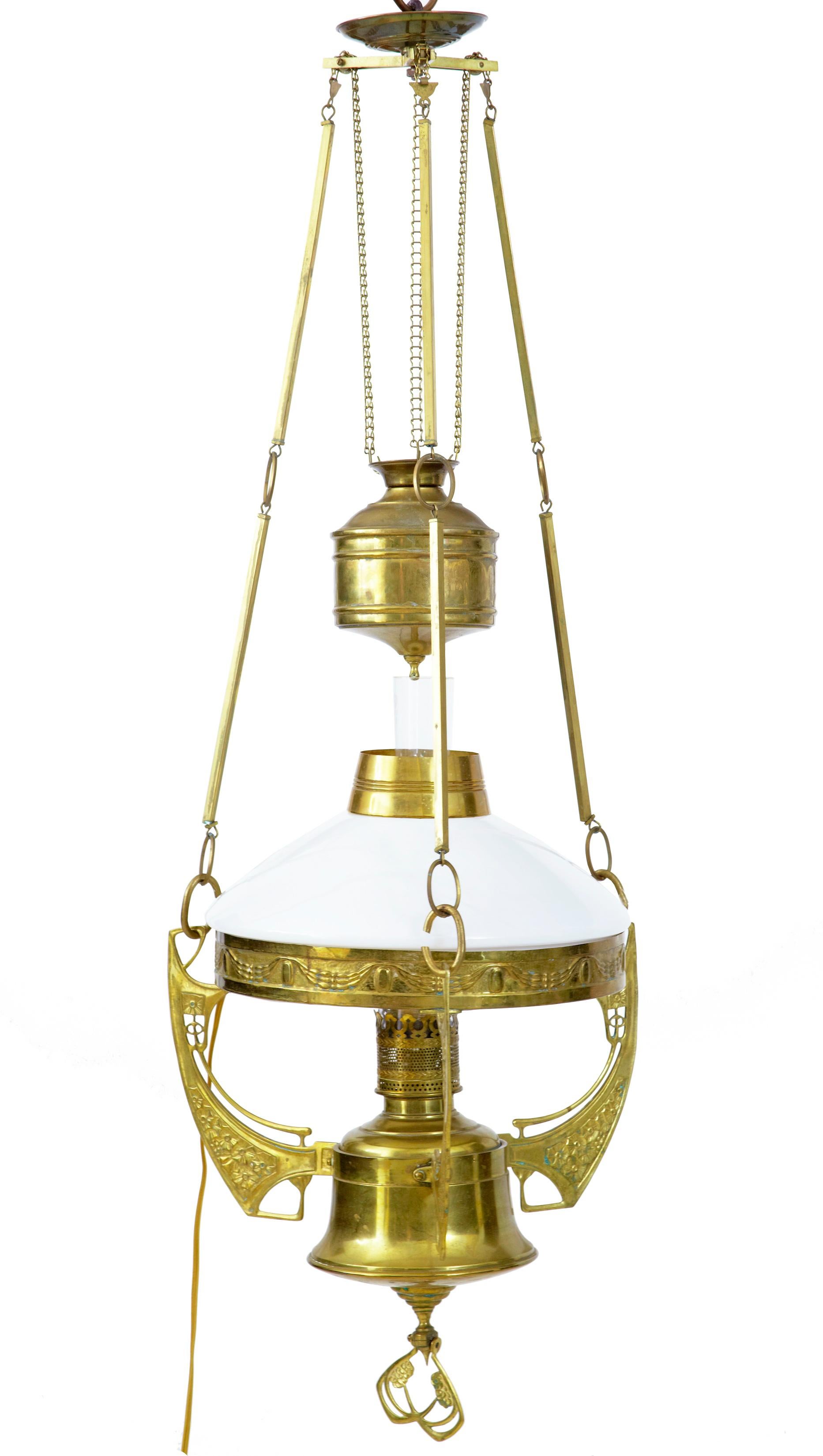 Late 19th century arts and crafts brass adjustable hanging lamp circa 1890.

Good quality pressed brass lamp with typical art and craft patterns.  Oil lamp with all its components intact, later fitted with 3 electric bulb holders. Height