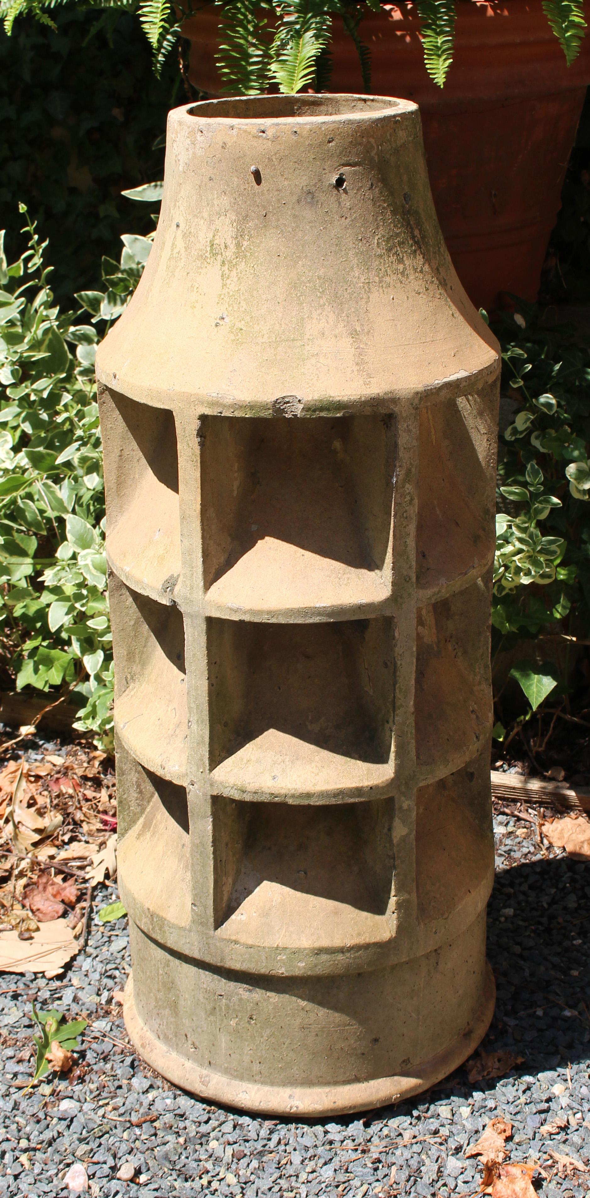 Arts & Crafts period terra cotta chimney pot, English. Late 19th century. Light sand brown color. Stacked circular vents create a lovely design and make it ideal as an uplight holder in a garden, decorative accent inside or out, etc.
31.75