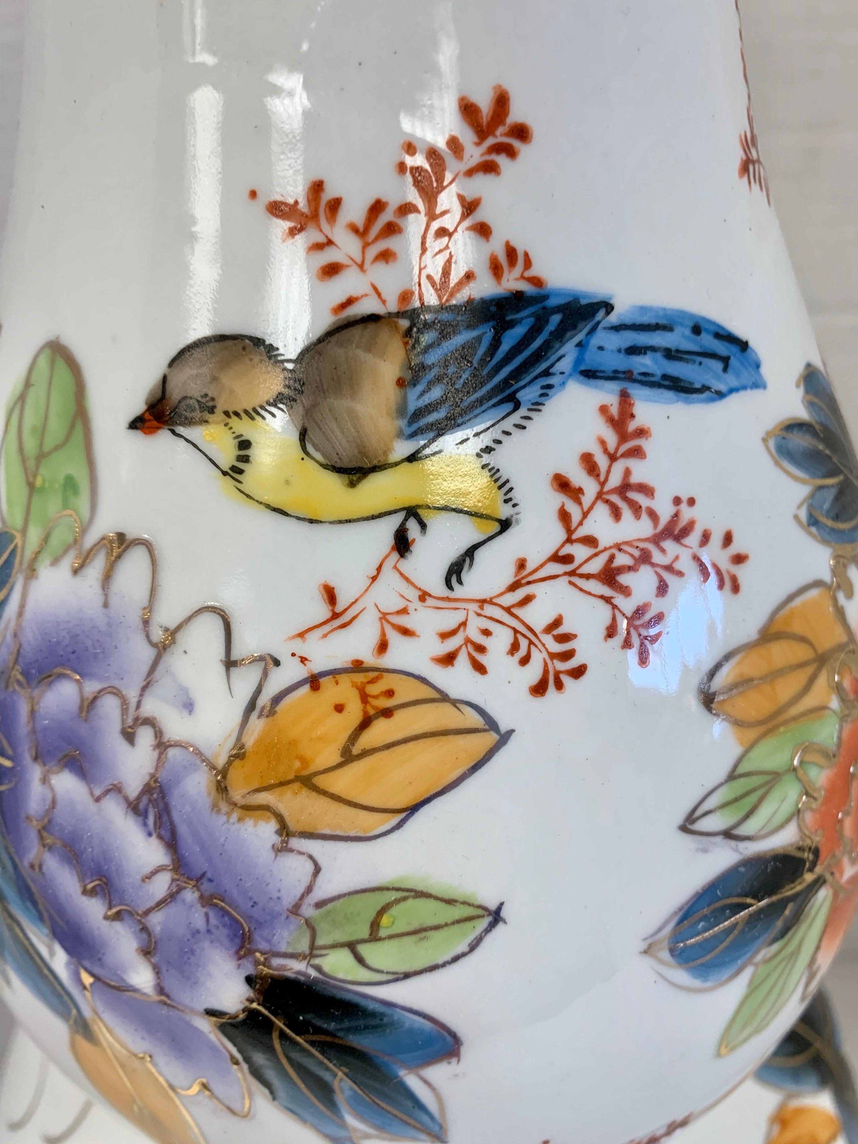 Elegant Chinese double gourd vase with colorful hand painted motif of peonies and birds. The double gourd is a symbol of fertility and considered to be good luck. No hallmarks.