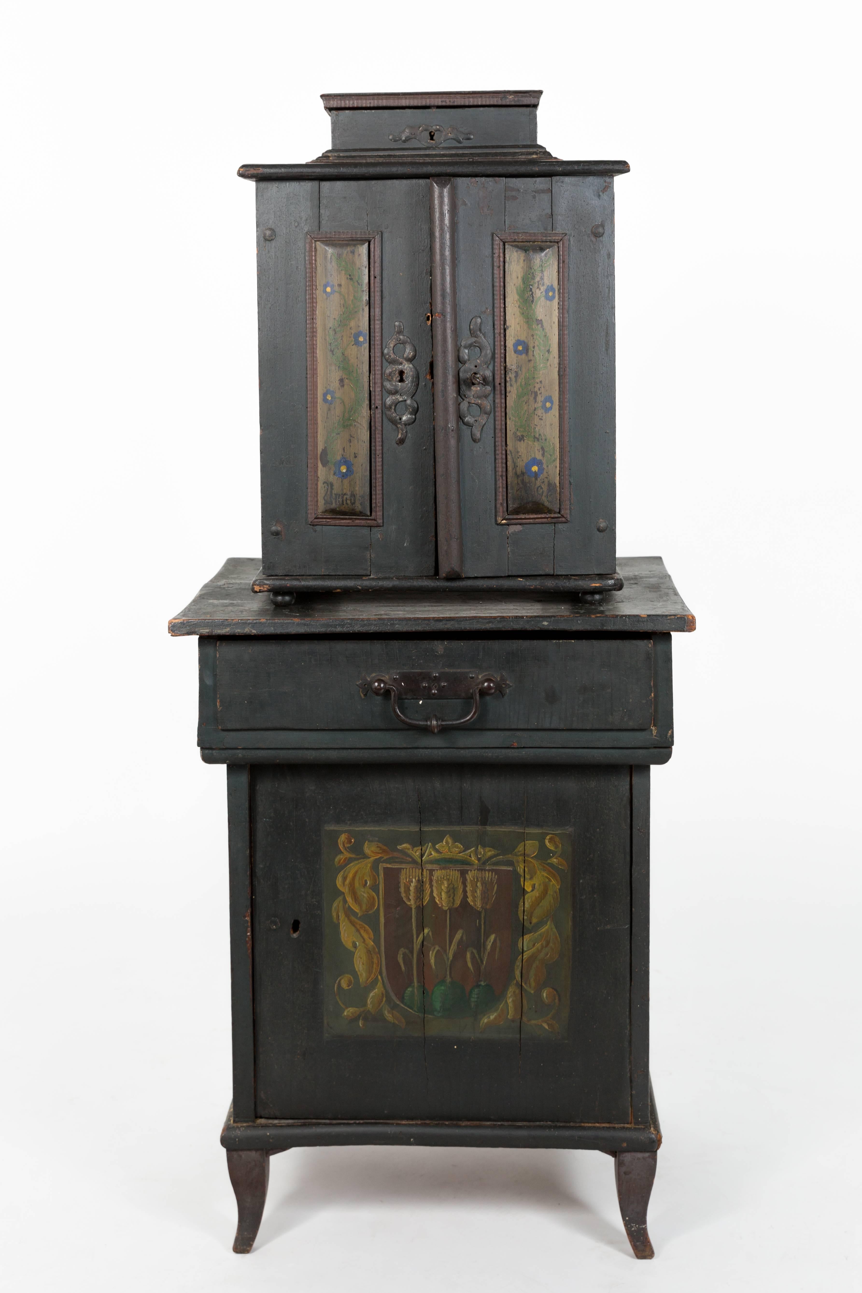 A late 19th century Austrian hand-painted country cabinet with drawers. It has 19 small drawers and one large.