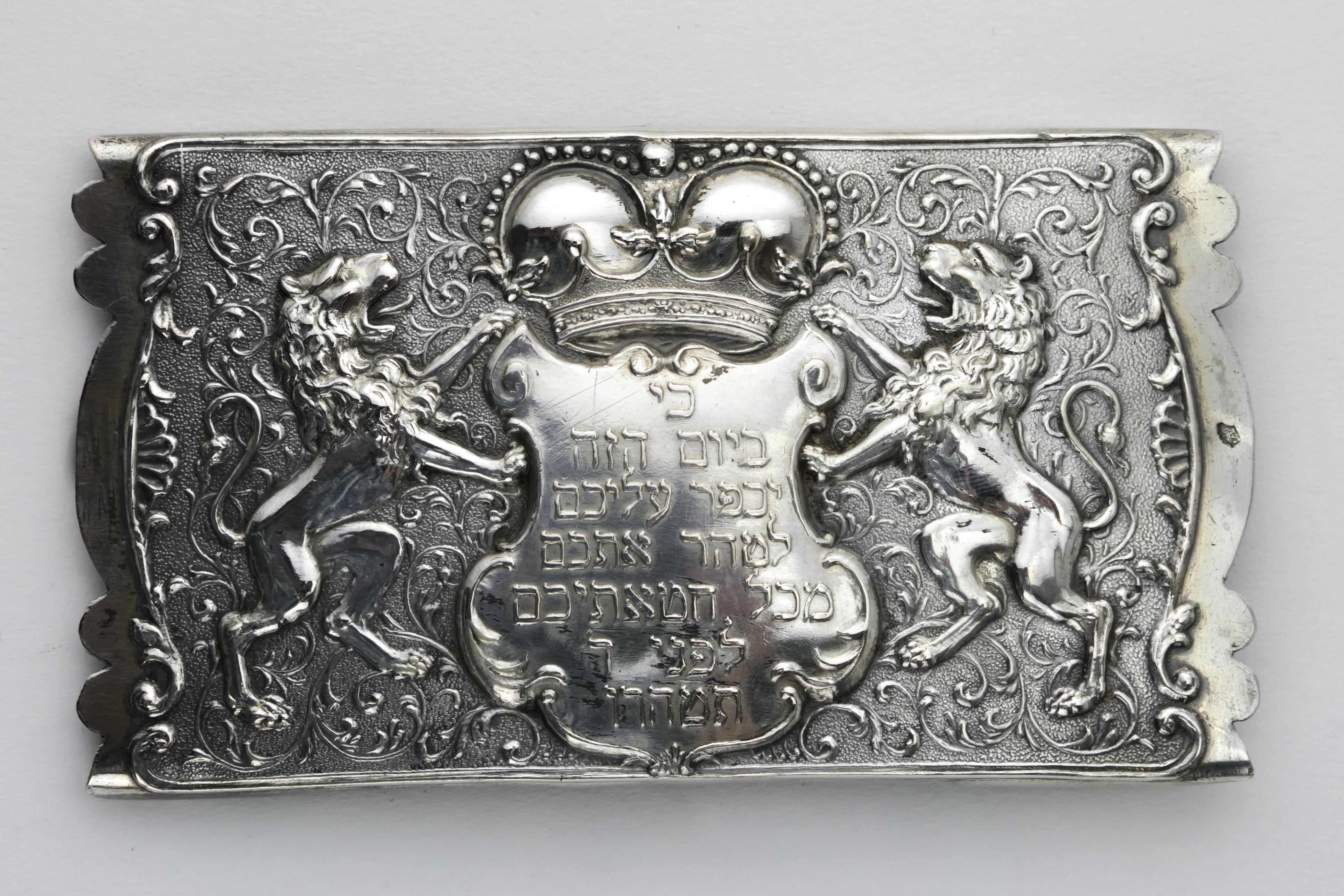 Handmade silver Yom Kippur belt buckle, Austro-Hungarian Empire, circa 1870.
Repoussé with Lions of Judah flanking a crowned cartouche whose interior reads in Hebrew “For on this day He will make atonement for you, to purify you from all your sins,