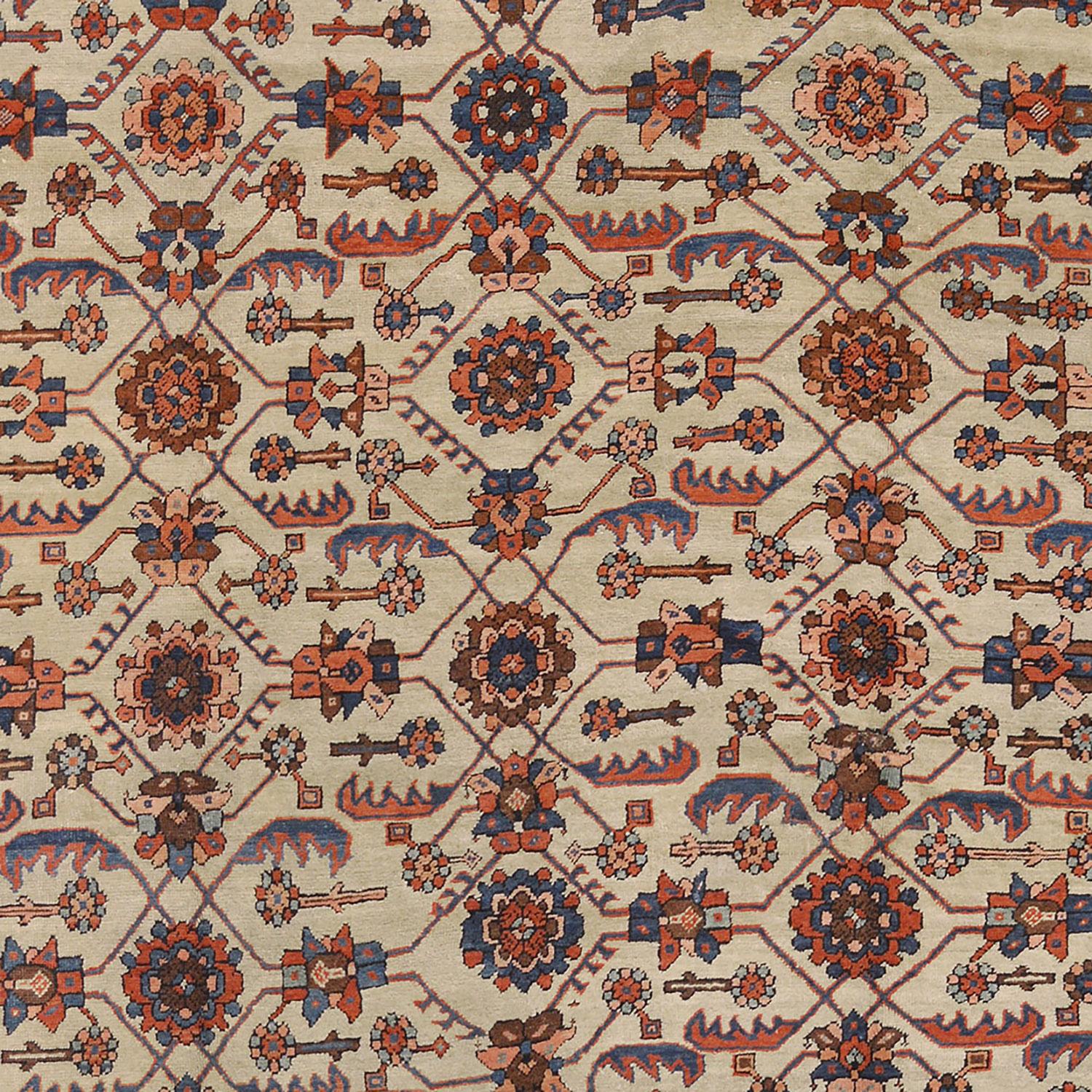 This traditional hand-woven Persian Bakhshaish rug has an ivory field of polychrome palmettes issuing angled vine forming lozenge lattice, in a matching linked rosette garland border, between complementary floral vine stripes, plain outer ivory line