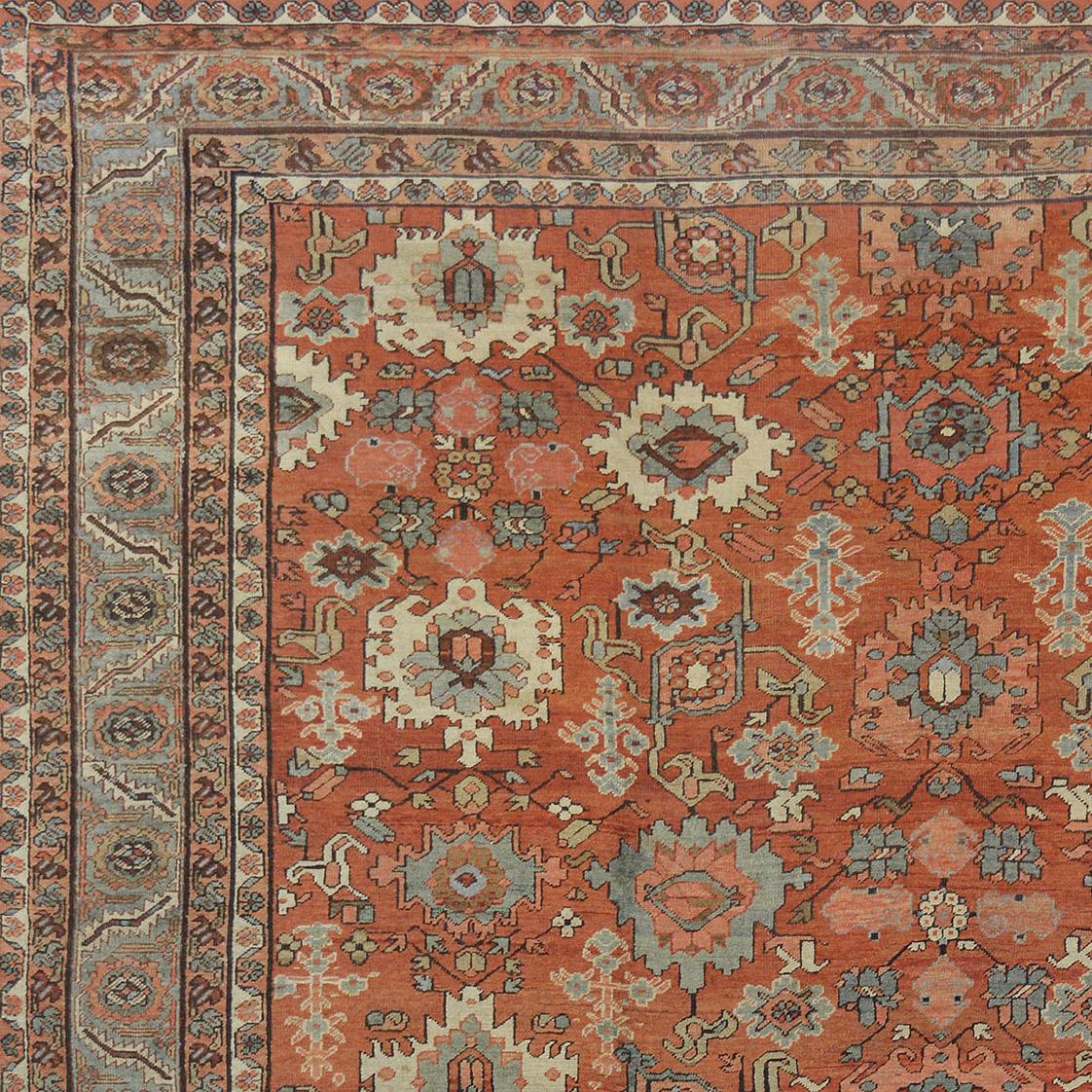 This traditional handwoven Persian Bakhshaish rug has a shaded terra cotta field of intricate polychrome palmette pendants issuing angled vines and geometric floral motif, in a shaded platinum scrolling palmette pendant vine border, between a