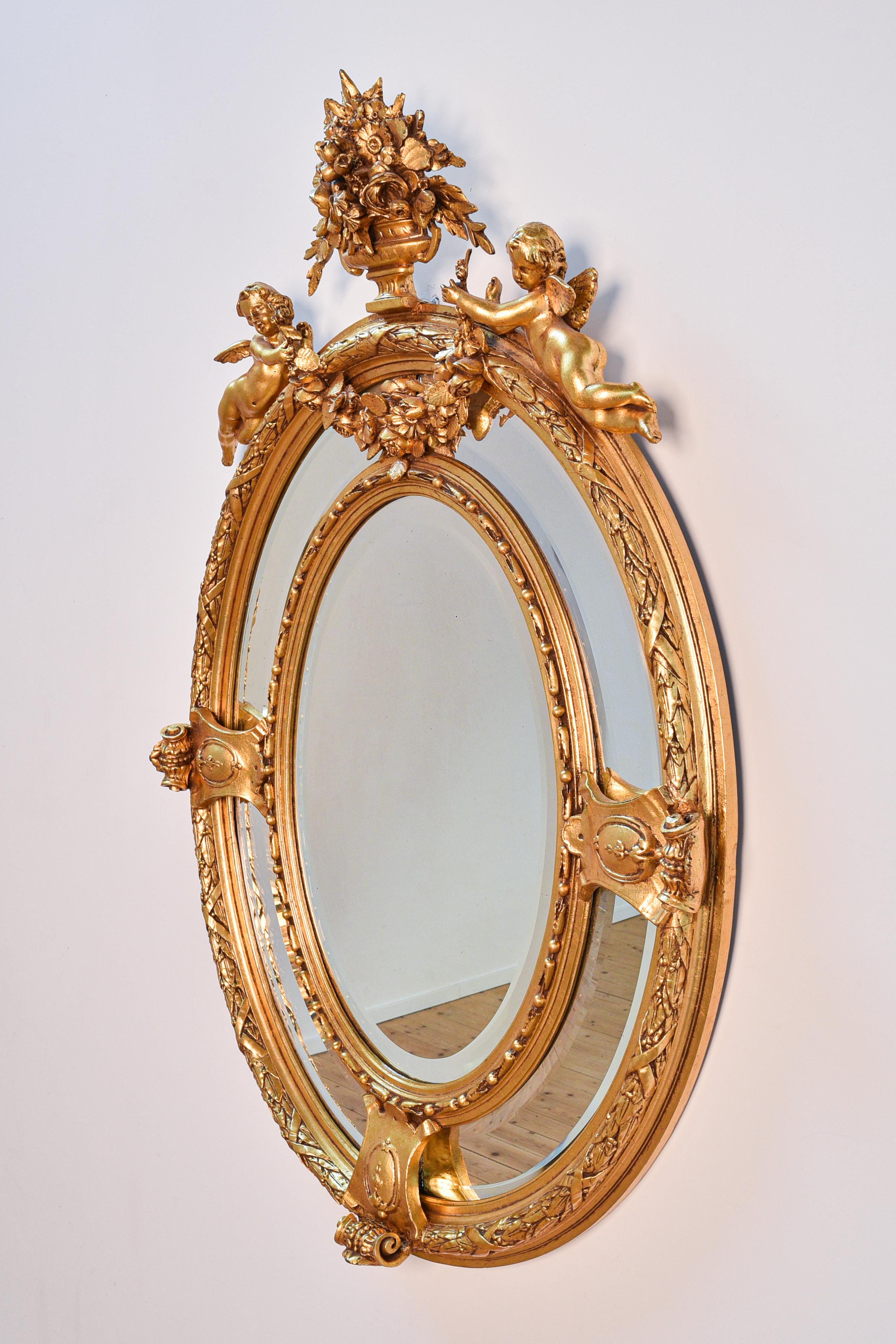 Late 19th century Italian antique baroque girandole mirror with wooden frame, decorated with angels and floral elements, cut glass. 