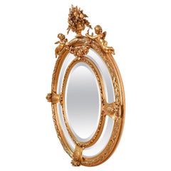 Late 19th century baroque mirror with angels and floral elements on wooden frame