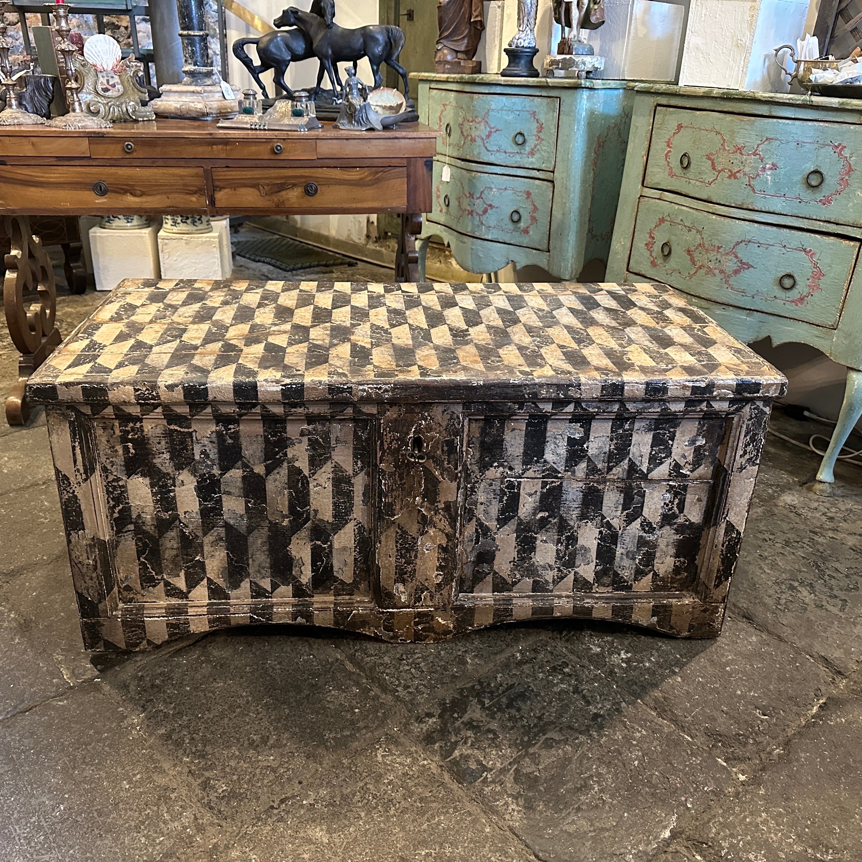 A Tuscanian blanket chest manufactured in Italy in the late 19th century, it's in original conditions and it has normal signs of use and age. The inside part it's white painted, the white and black decor depicts geometrical motifs and it's suitable