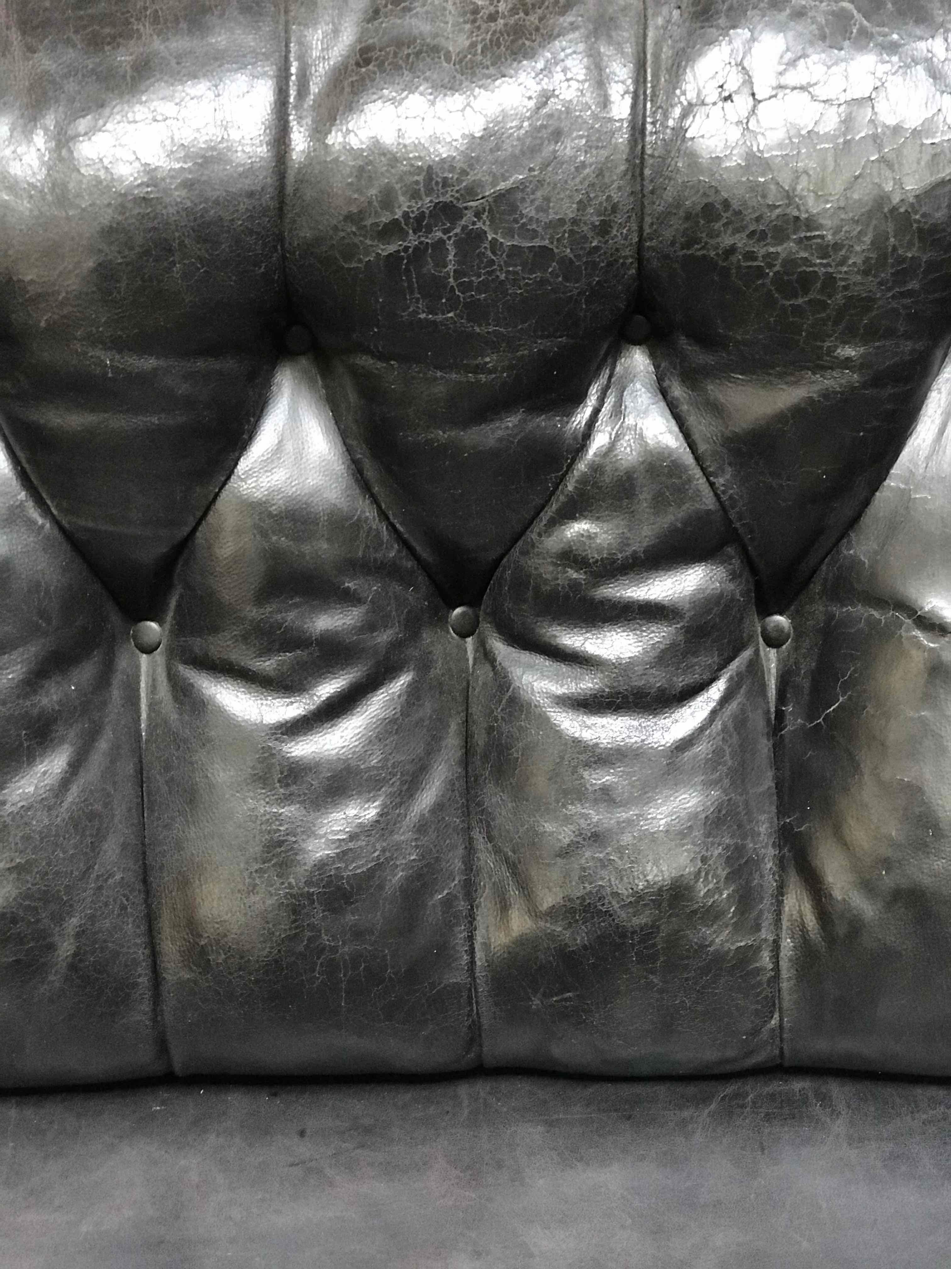 Late 19th century black leather tufted Chesterfield sofa from Sweden.