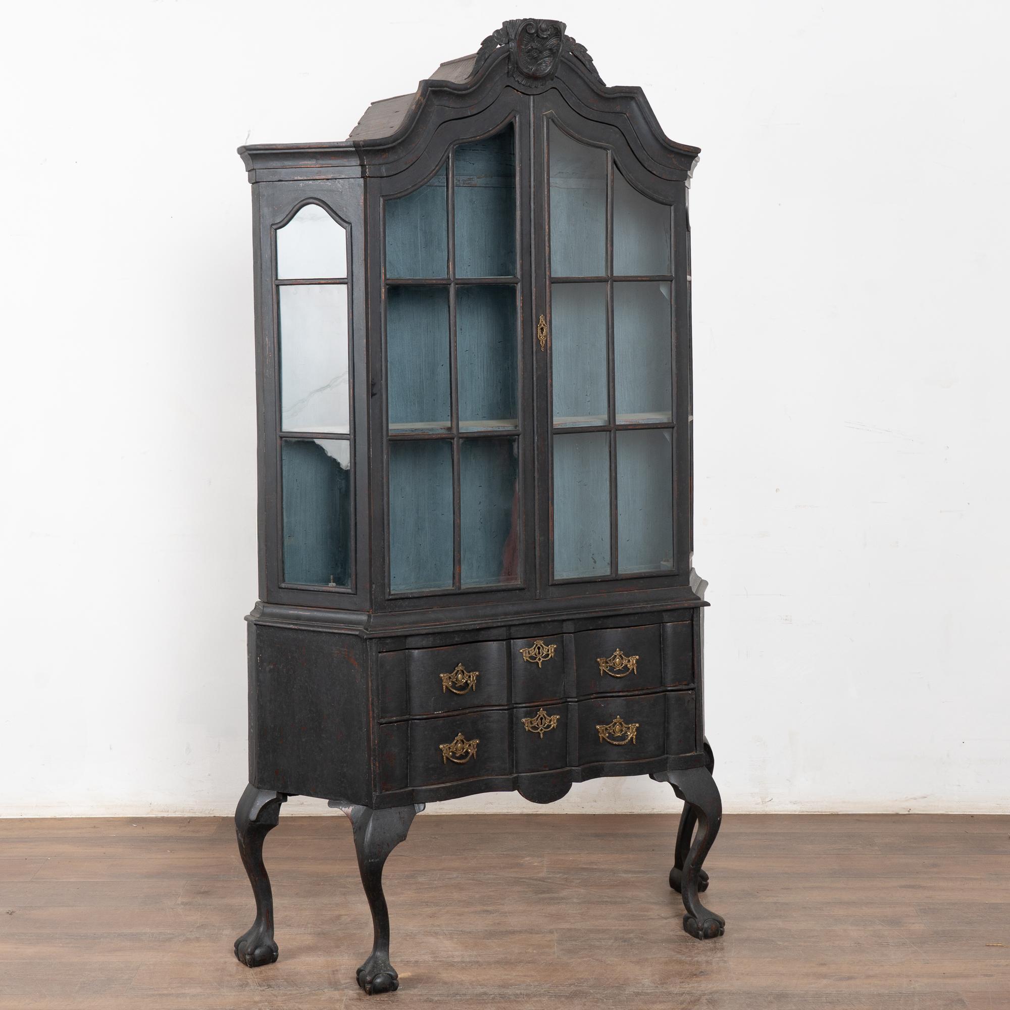 Lovely rococo curves and carvings accentuate this striking Vitrine or display cabinet.
Note the pane glass doors and canted sides that will provide wonderful display of any collection held within.
The newer, professionally applied black painted