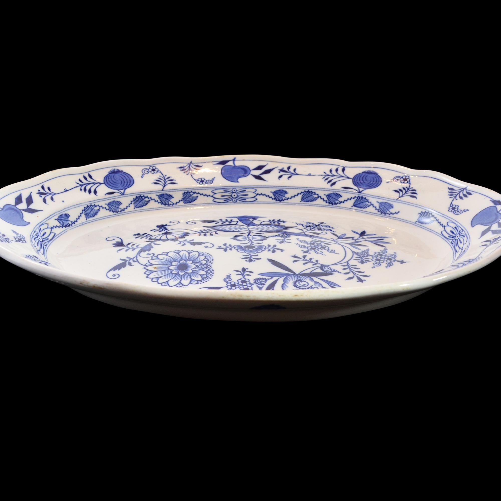 This large platter has the classic Meissen blue onion design. The manufacturer Brown-Westhead, Moore & Co., operated 1862-1904 in the Staffordshire pottery area. The platter is marked with the maker's mark and the pattern name, MEISSEN. In addition