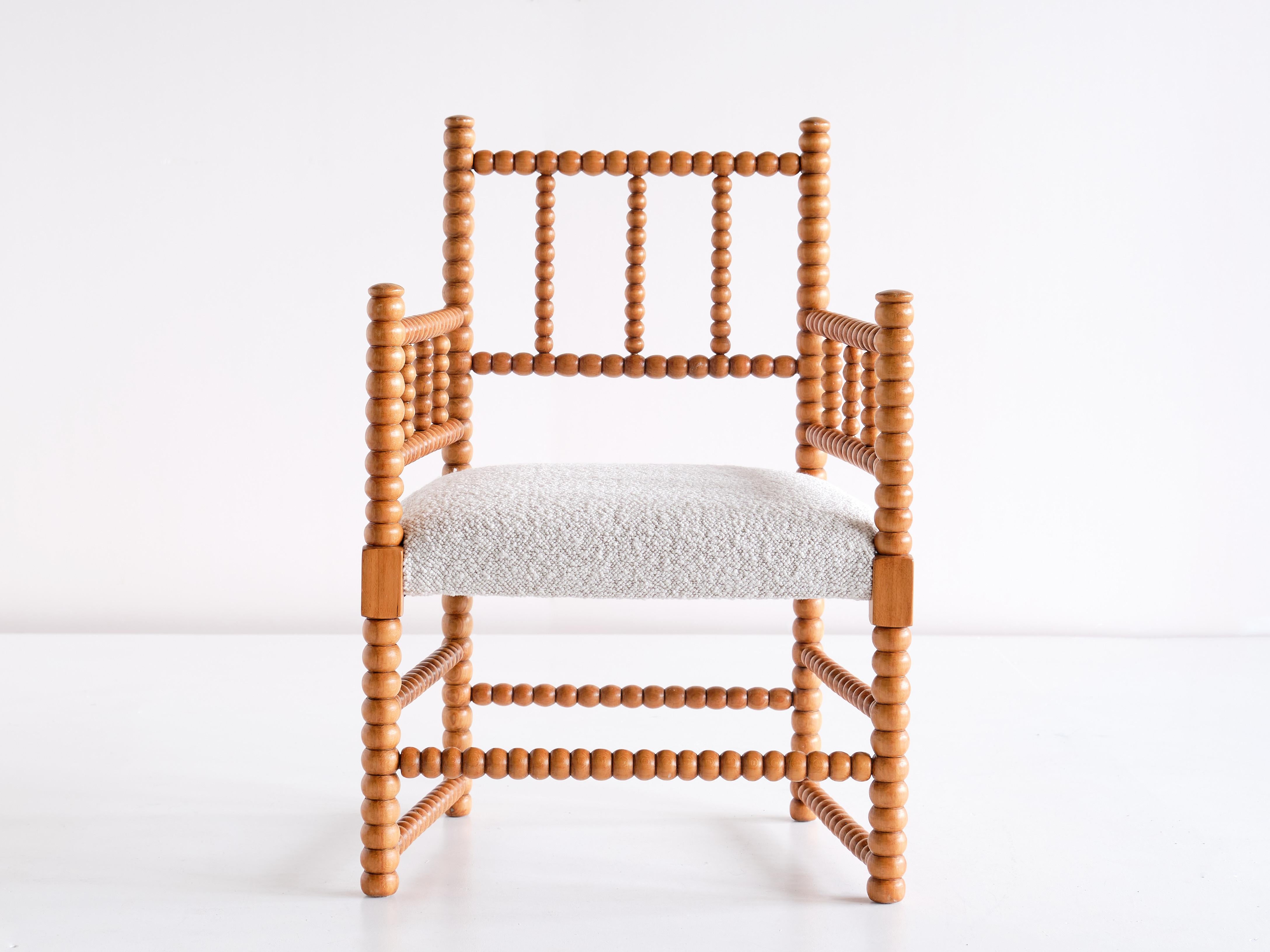 This charming small side chair was made in the Netherlands in the late 19th century. Every section of the frame has beautifully turned solid beech wood elements creating the bobbin structure. The seat has been fully reconditioned and newly