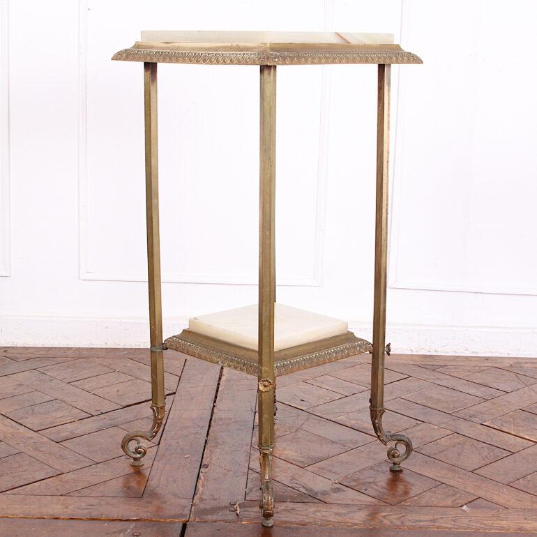A late-19th century two-tier Victorian stand with finely-cast details to the brass frame and ornate brass scrolled feet. Onyx surfaces, upper and lower, set within the brass frame. C. 1890.



 