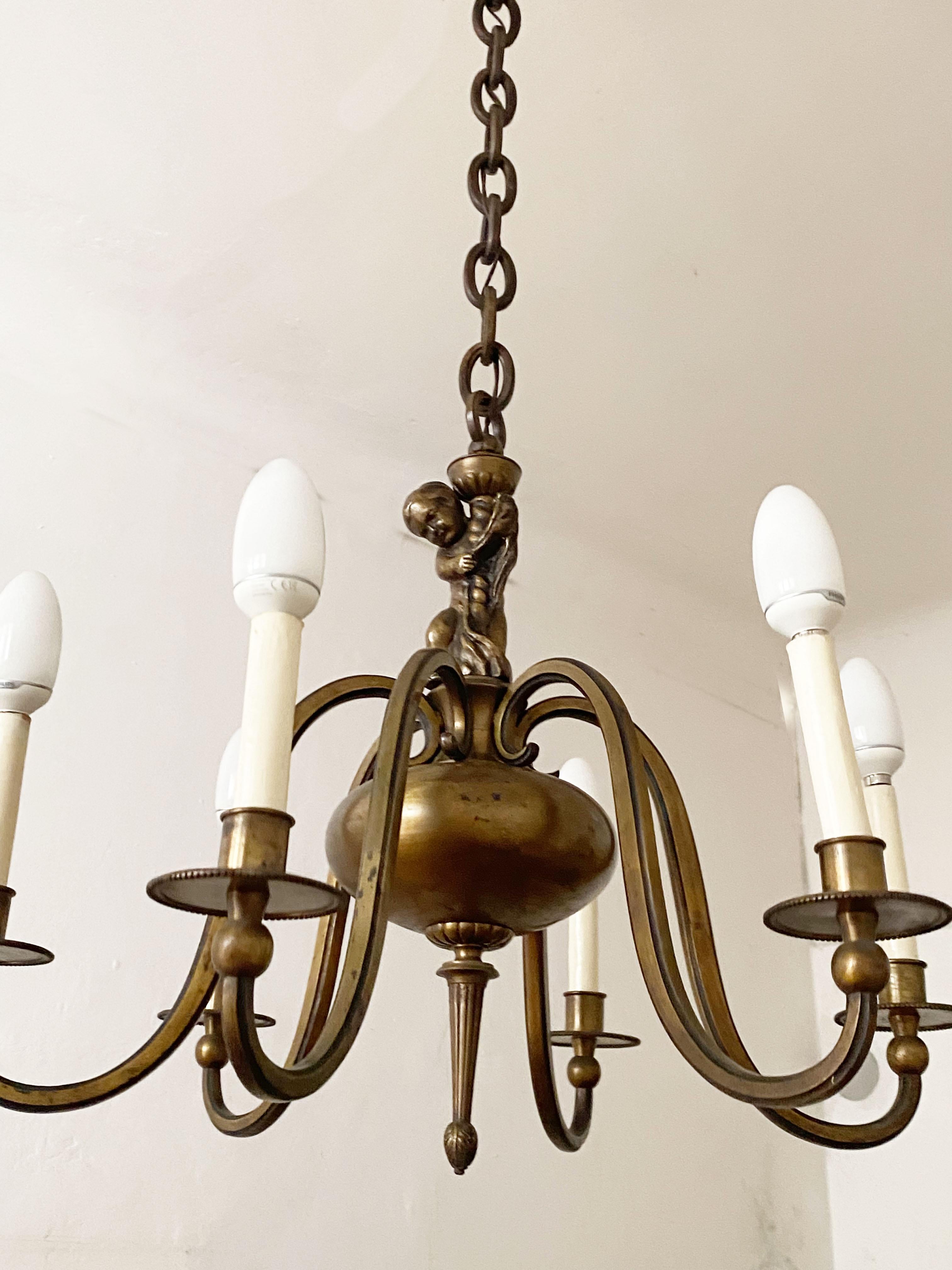 Brass chandelier made in the 1880s in Vienna.
A beautiful form body. Six flamed fitted with E14 sockets and an baroque cherub in the middle.
Original condition.
