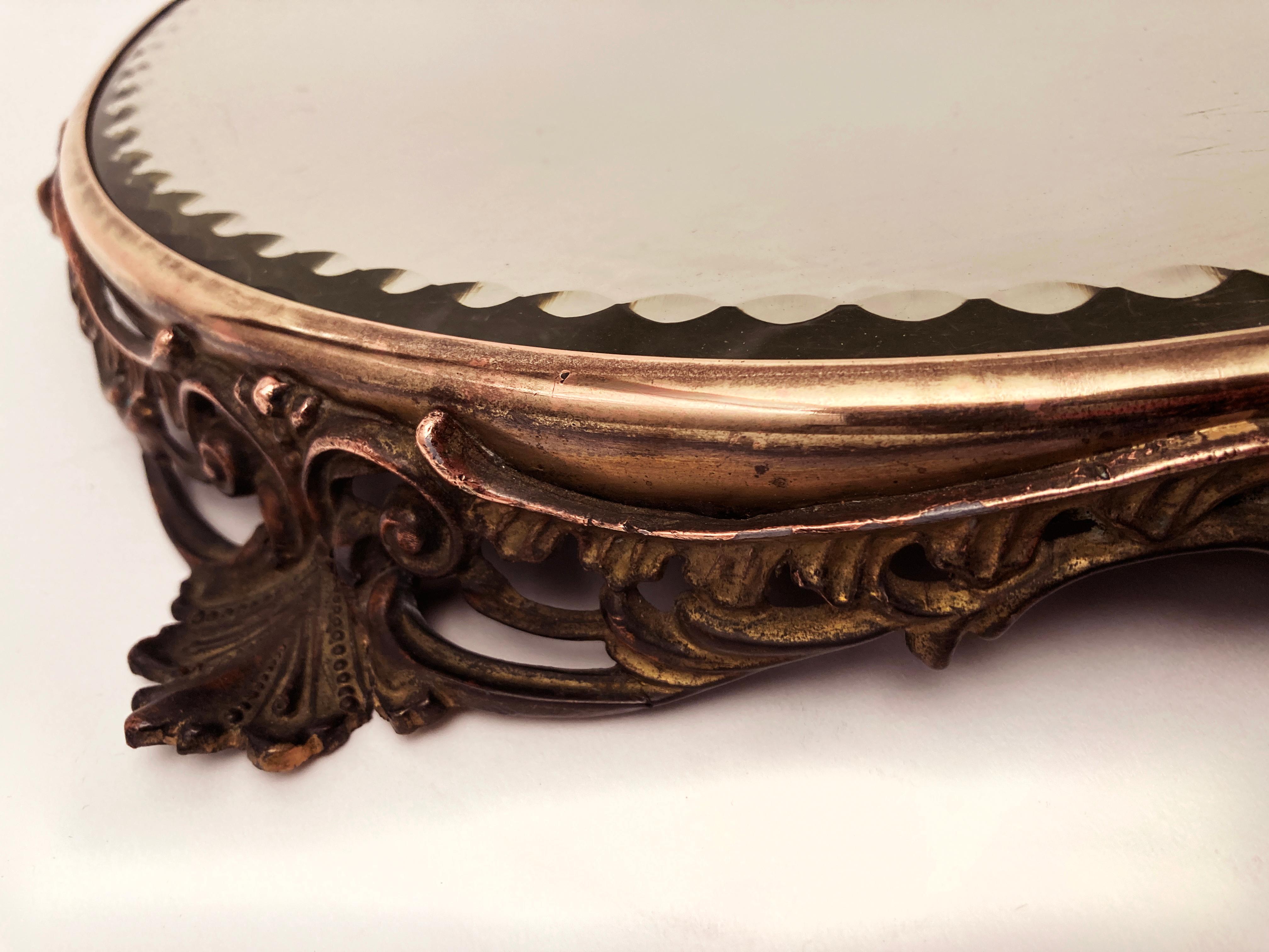This beautiful and well patinated plateau table mirror is perfect for those who want something texturally unique with depth and richness from a period known for ornate detail. The exposed copper is no doubt a result of polishing over the years. But,