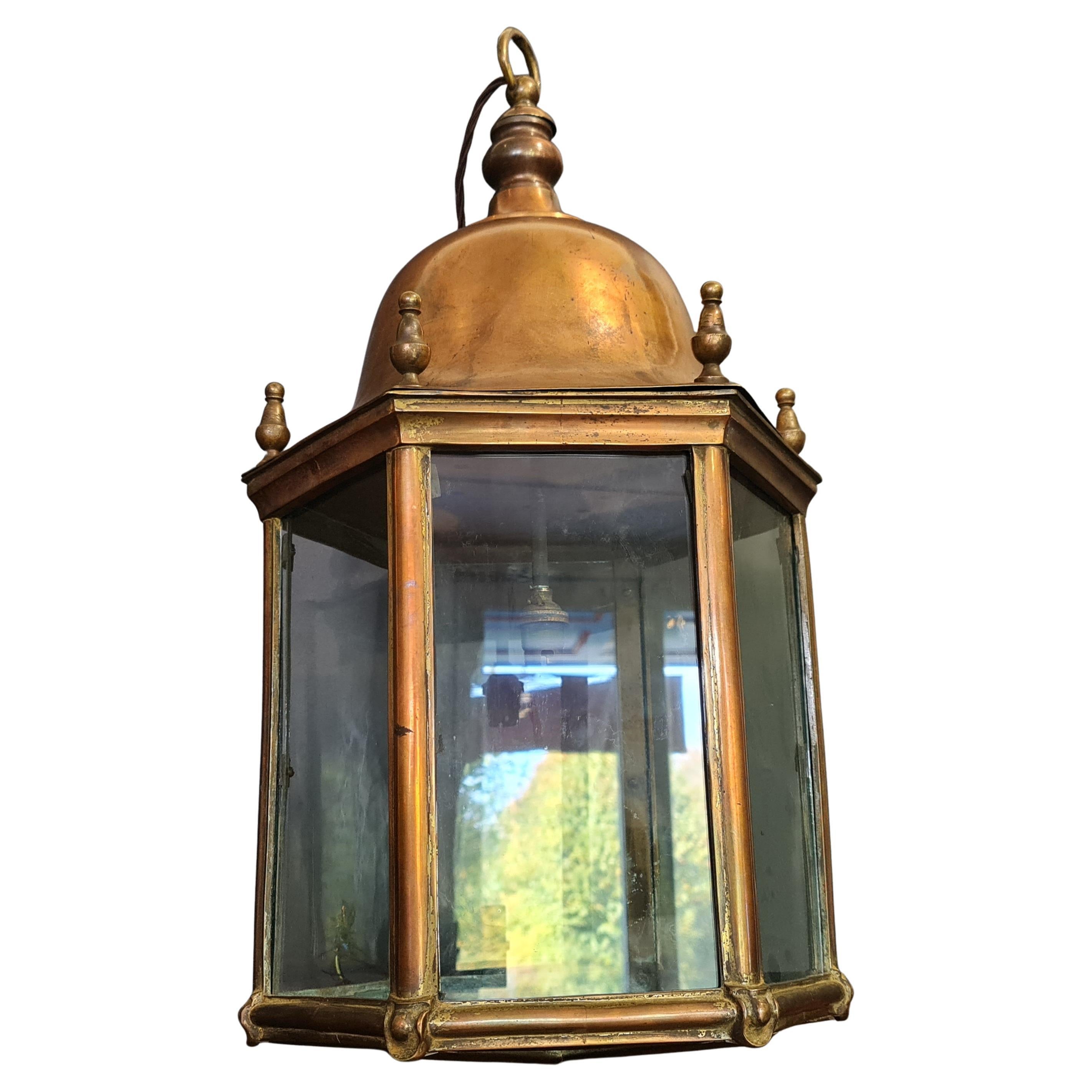 Good quality cast brass lantern  dating to around 1890. The lantern has a beautiful dark patina, the glass is old period glass but not original to the lantern. It has been recently re-wired to UK standards.