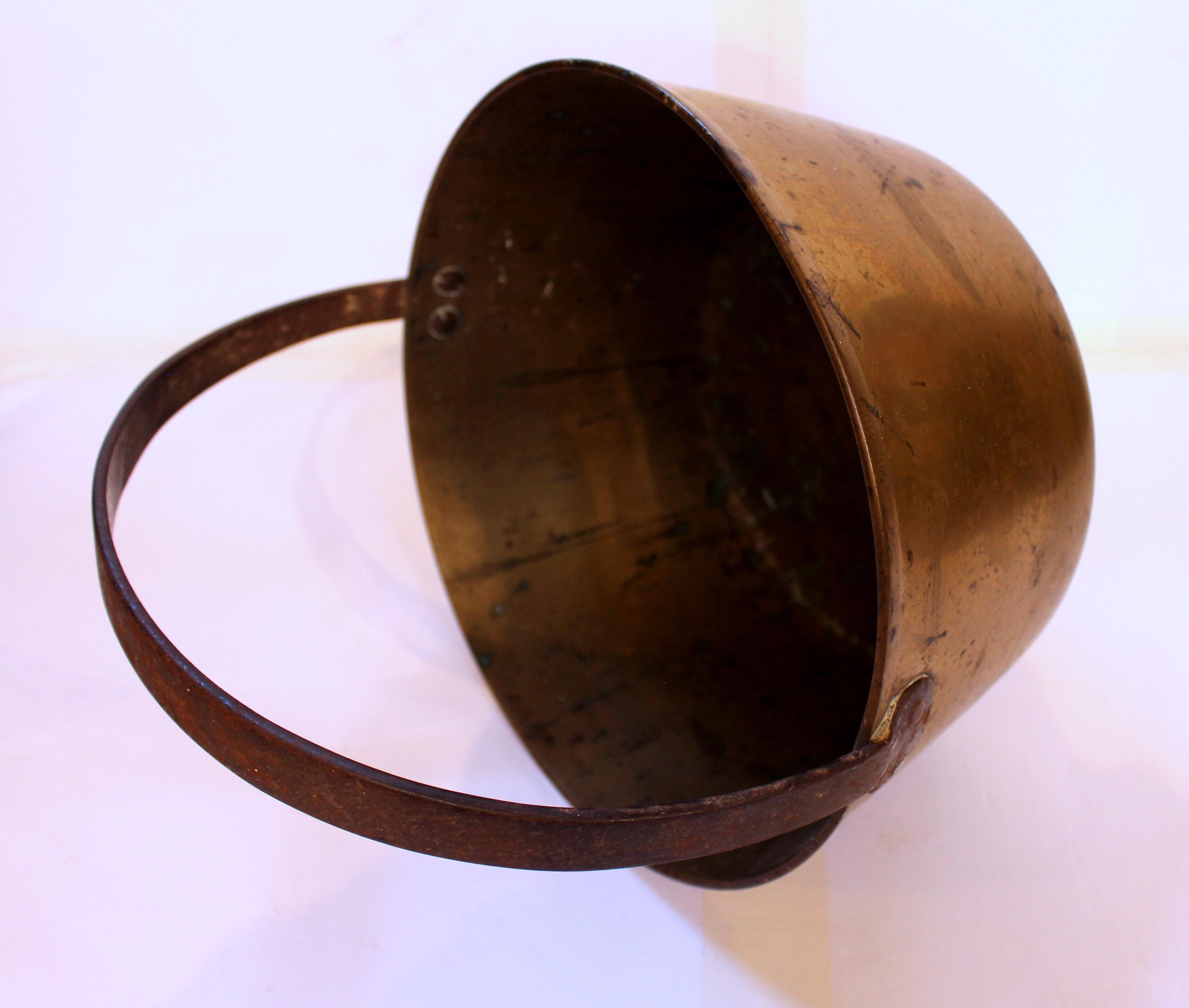 Late 19th century brass jam pot with iron handle, English. Heavy gauge spun brass and forged iron handle make this piece unusually heavy, made to last through the ages.
12