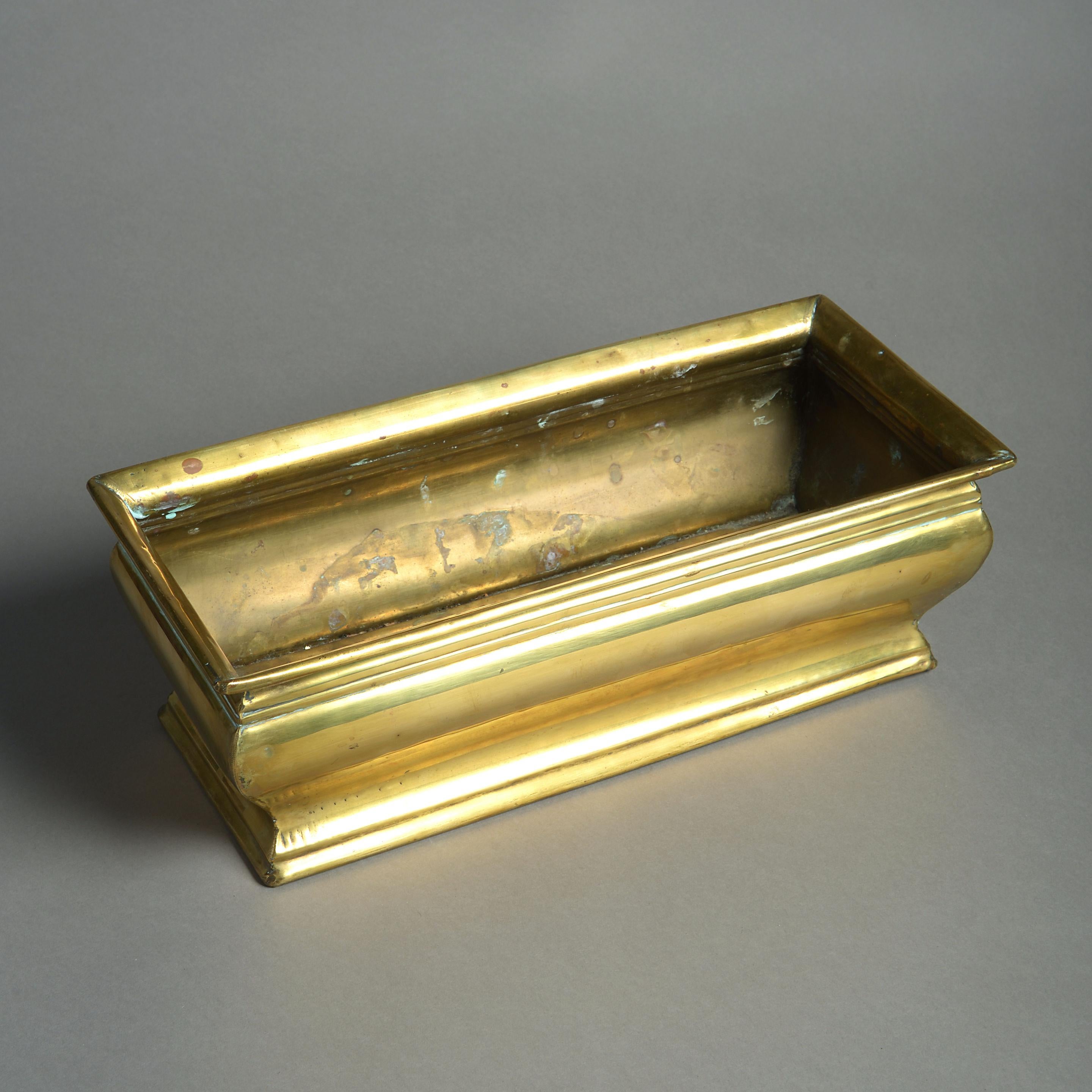 A late 19th century brass planter, of rectangular form, having shaped sides in the George I taste.
 