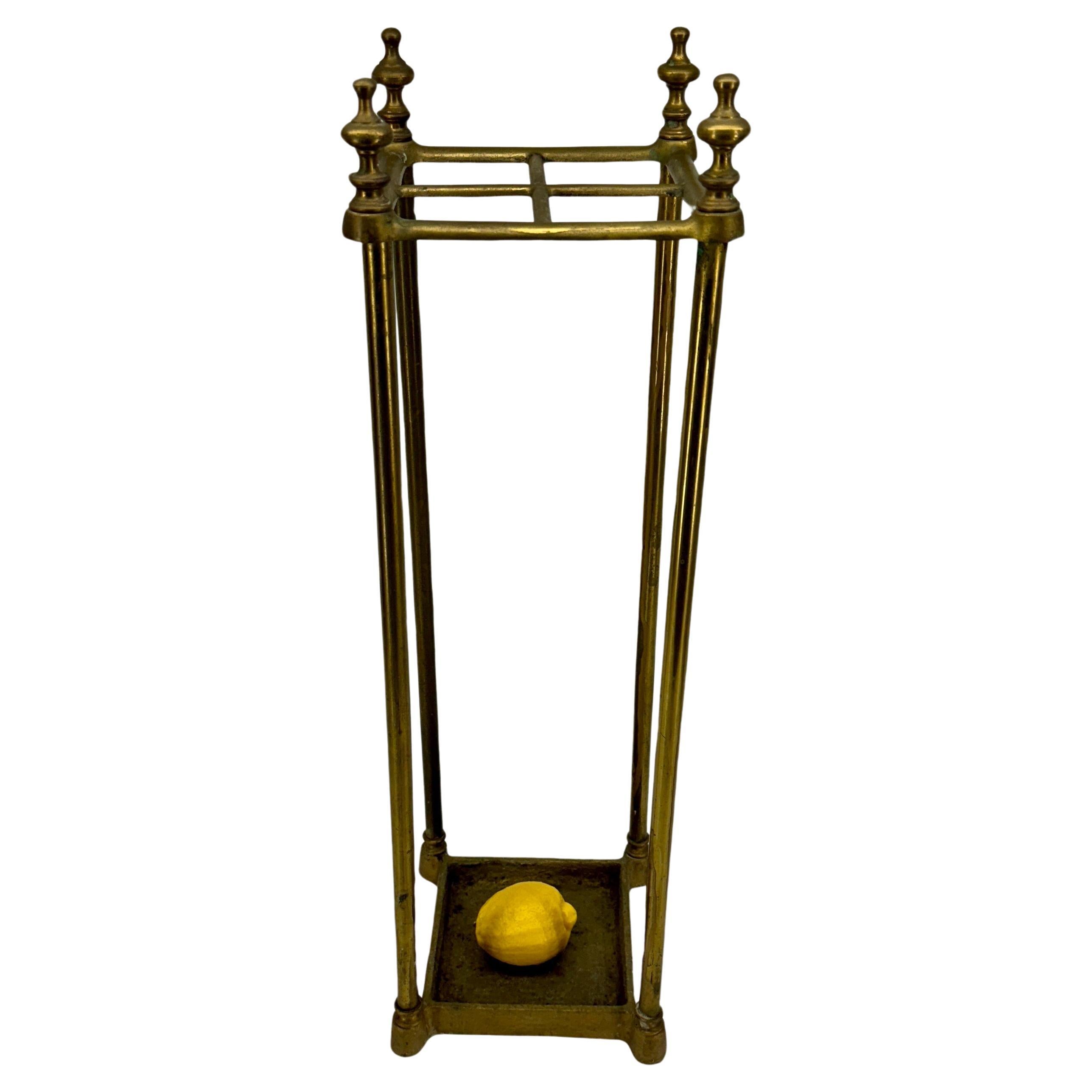 English Brass Umbrella or Cane Stand, circa 1890's

This vintage umbrella stand or cane stand makes an essential addition to your entryway. Beautifully sculpted, it features an elegant classic frame with an attached drip tray below protecting your