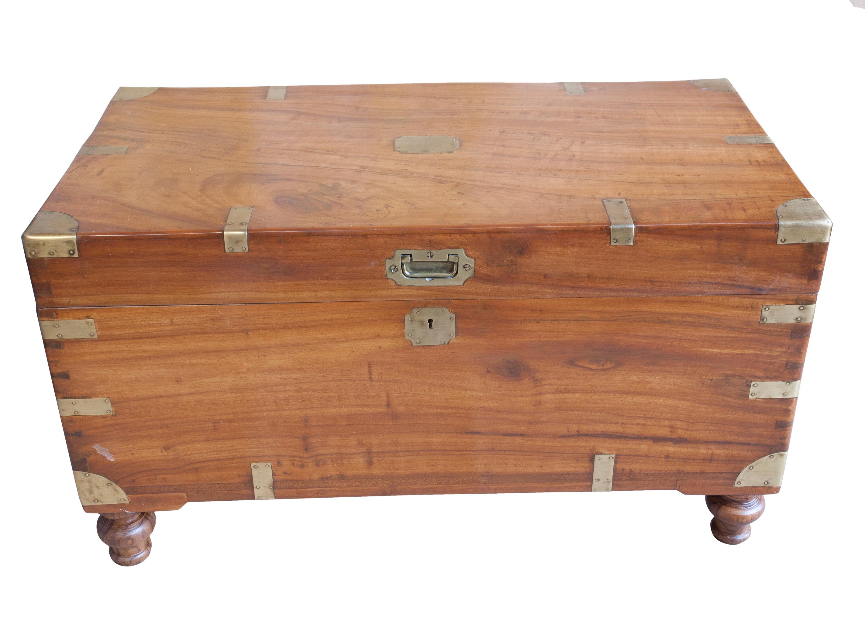 Classic British campaign camphor wood sea chest. Brass straps and handles, recessed brass pull and escutcheon with working lock and key. Feet were added to accommodate use as a coffee table (keeps your feet from hitting the box). Still has its