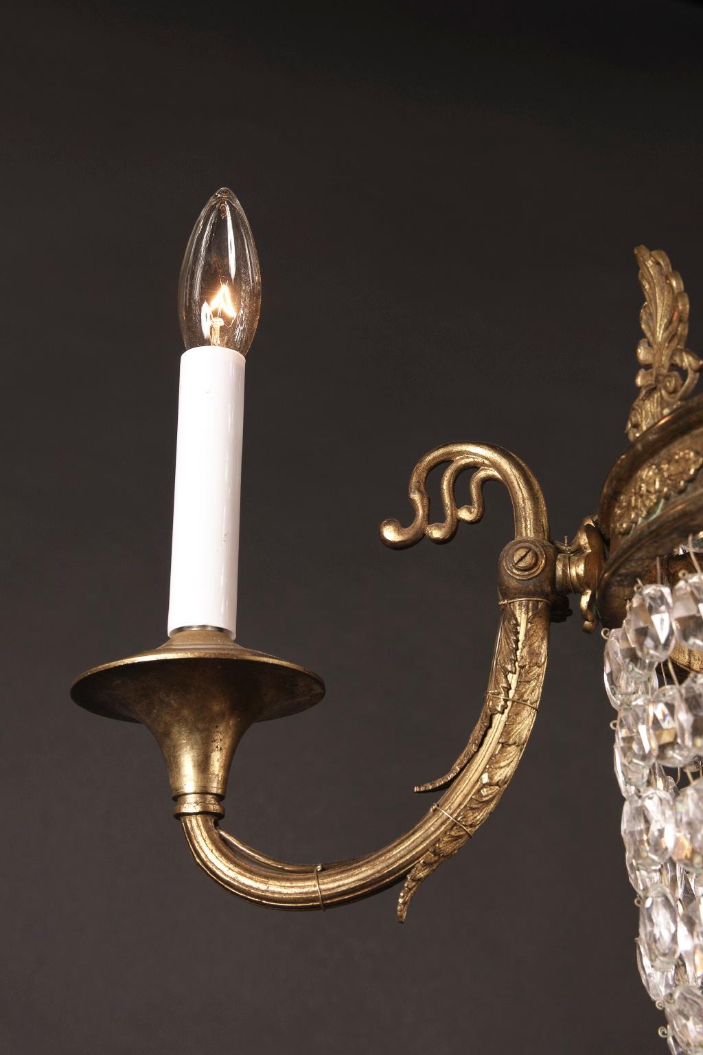 Small late 19th century French bronze and crystal 3 This small Empire chandelier is made of bronze and draped with oval cut crystal beads. The French antique piece dates back to the late 19th century. The crown at top is adorned with large palmetto
