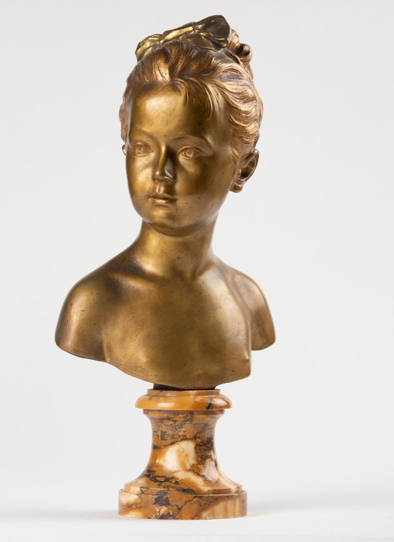 A French bust in bronze with original gold patina is derived from a masterpiece by Jean-Antoine Houdon. The original Bust of Louise Brongniart (1772-1845) was made of terracotta in 1777 and exhibited in the Louvre in Paris. Houdon's busts of Louise